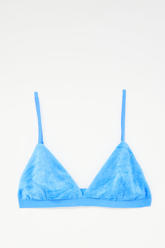 The Baserange Mississippi Bra in Zinn Blue, made from soft terry cloth with thin adjustable straps, is laid flat on a white background.