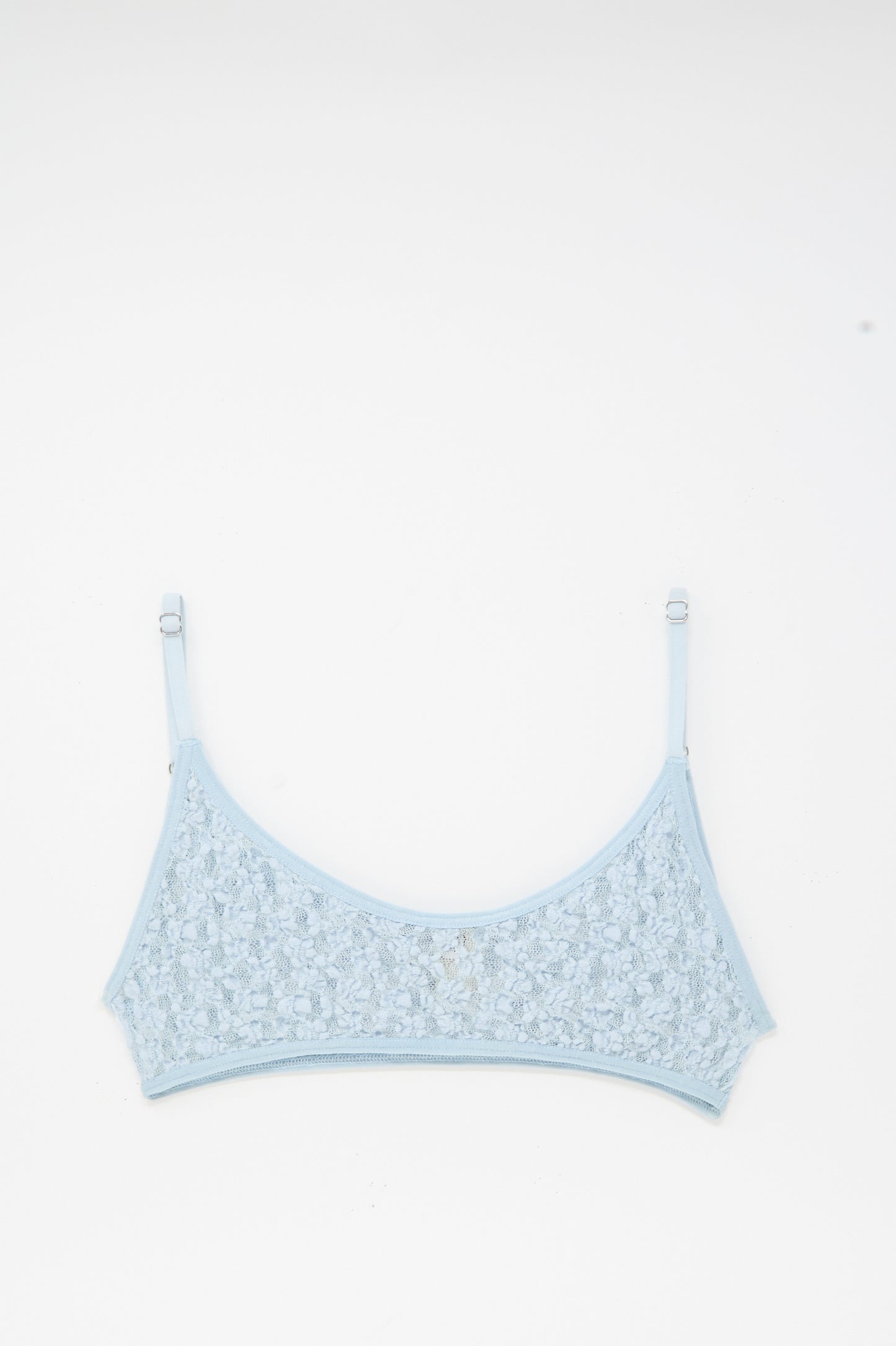 The Baserange Musial Bra in Dona Blue, featuring adjustable straps and delicate lace, is laid flat on a white background.
