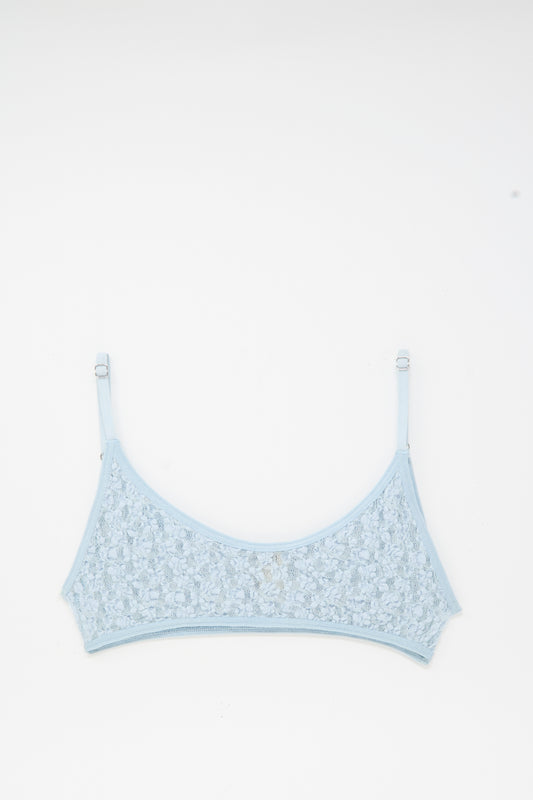 The Baserange Musial Bra in Dona Blue, featuring adjustable straps and delicate lace, is laid flat on a white background.
