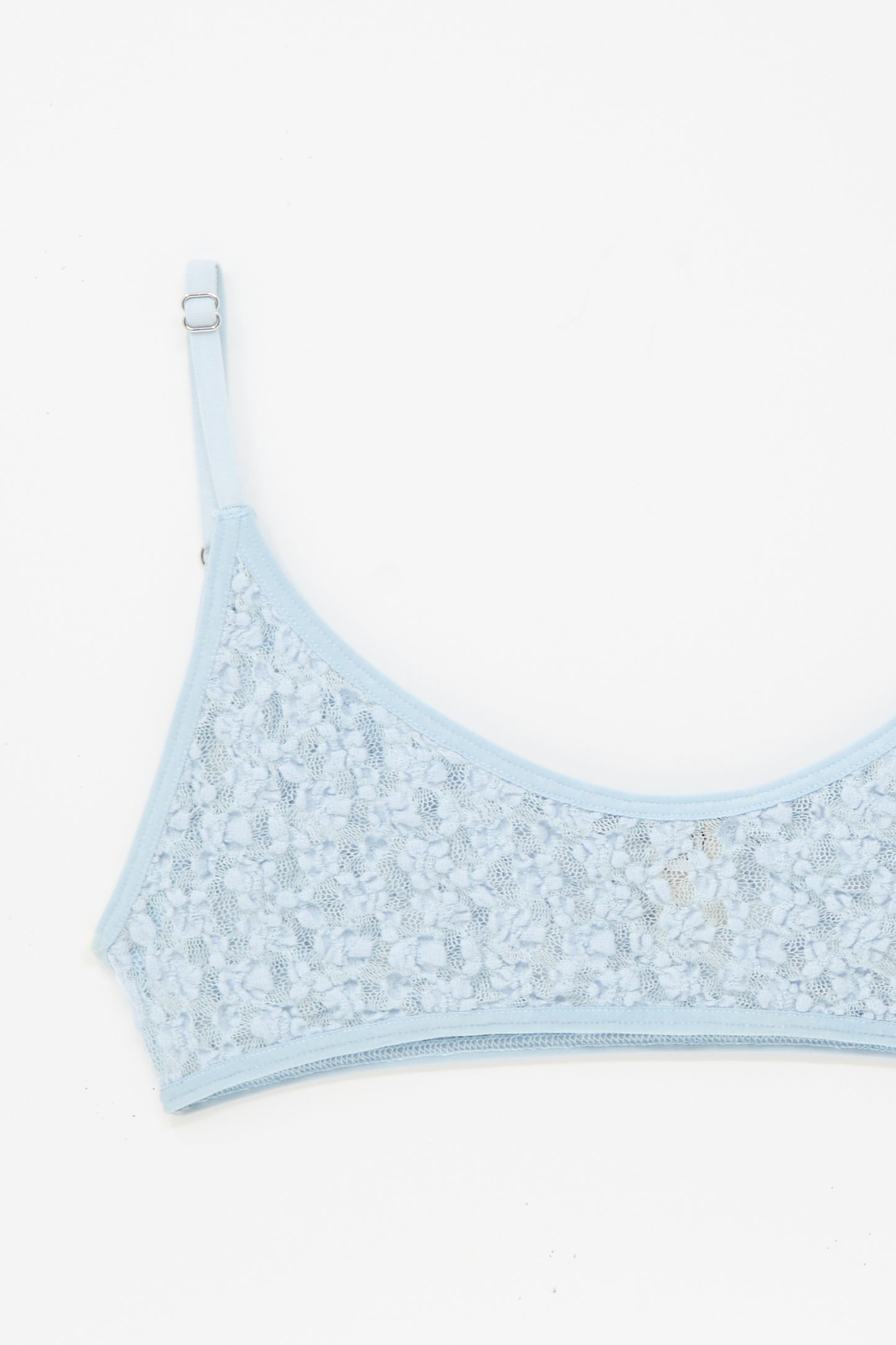 The Musial Bra in Dona Blue by Baserange, featuring adjustable straps and delicate lace, is pictured against a white background with only the upper section visible.