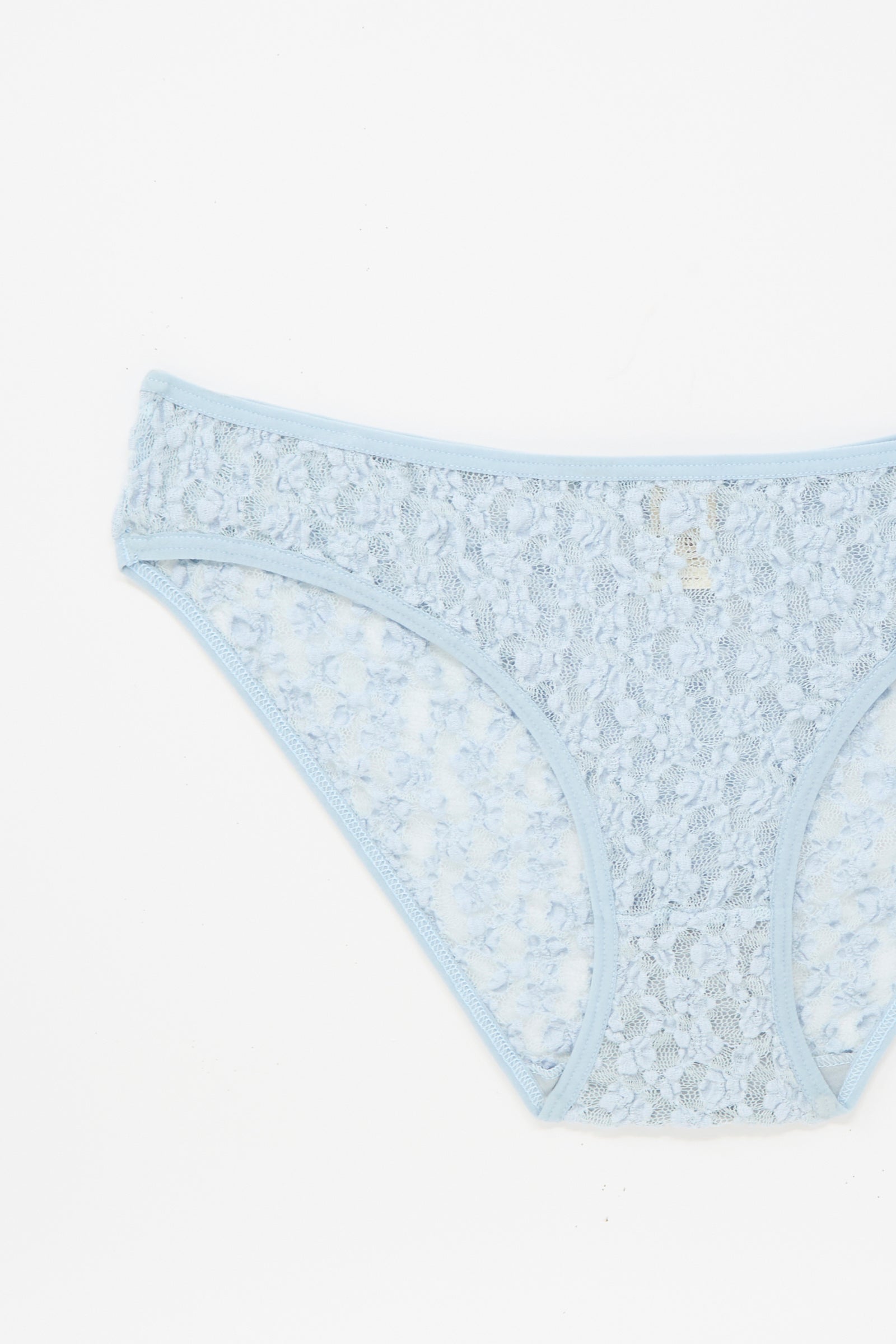 The Musial Pant in Dona Blue by Baserange is a light blue, low-rise lace underpant made in Portugal, shown from the front on a white background.
