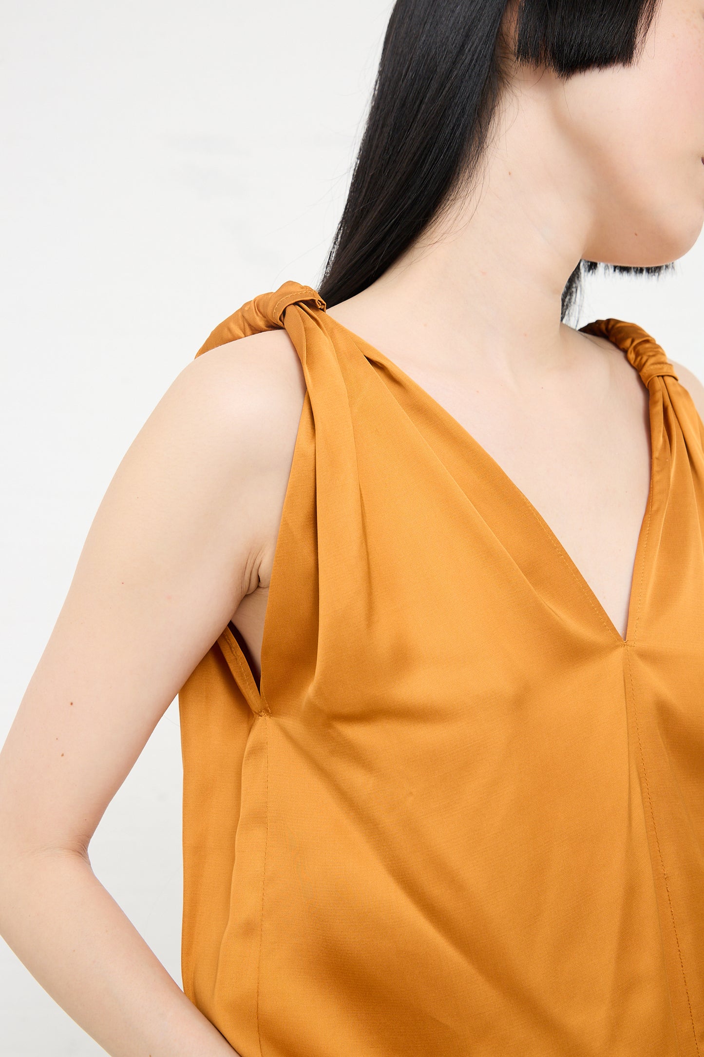 Woman wearing a Neil Top in Mina Copper by Baserange, made from sustainable ecovero viscose.