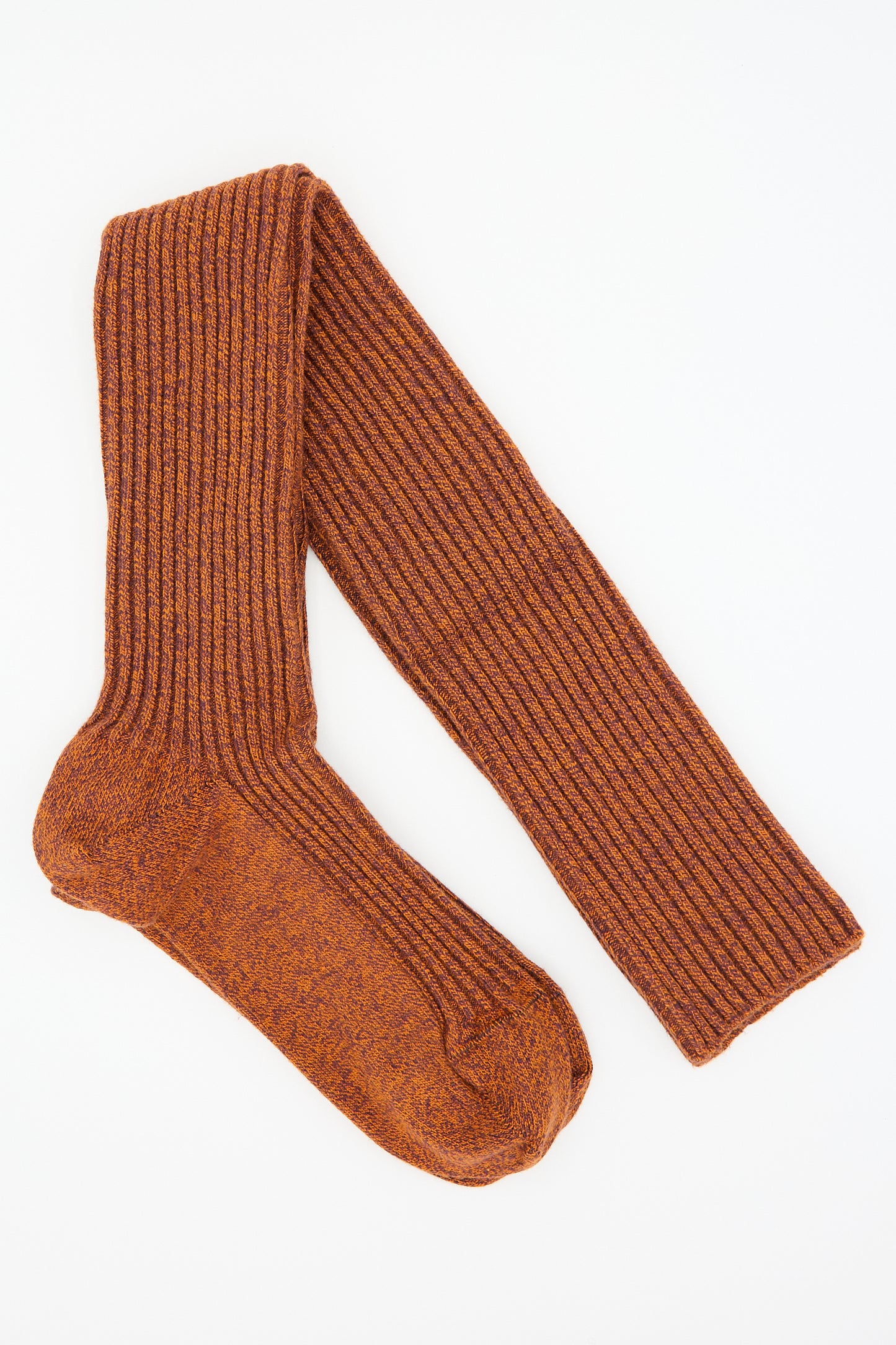 A single "Overknee Sock in Angle Burgundy and Rust" by Baserange, made from organic cotton with a ribbed pattern and a folded leg, lies flat against a white background.