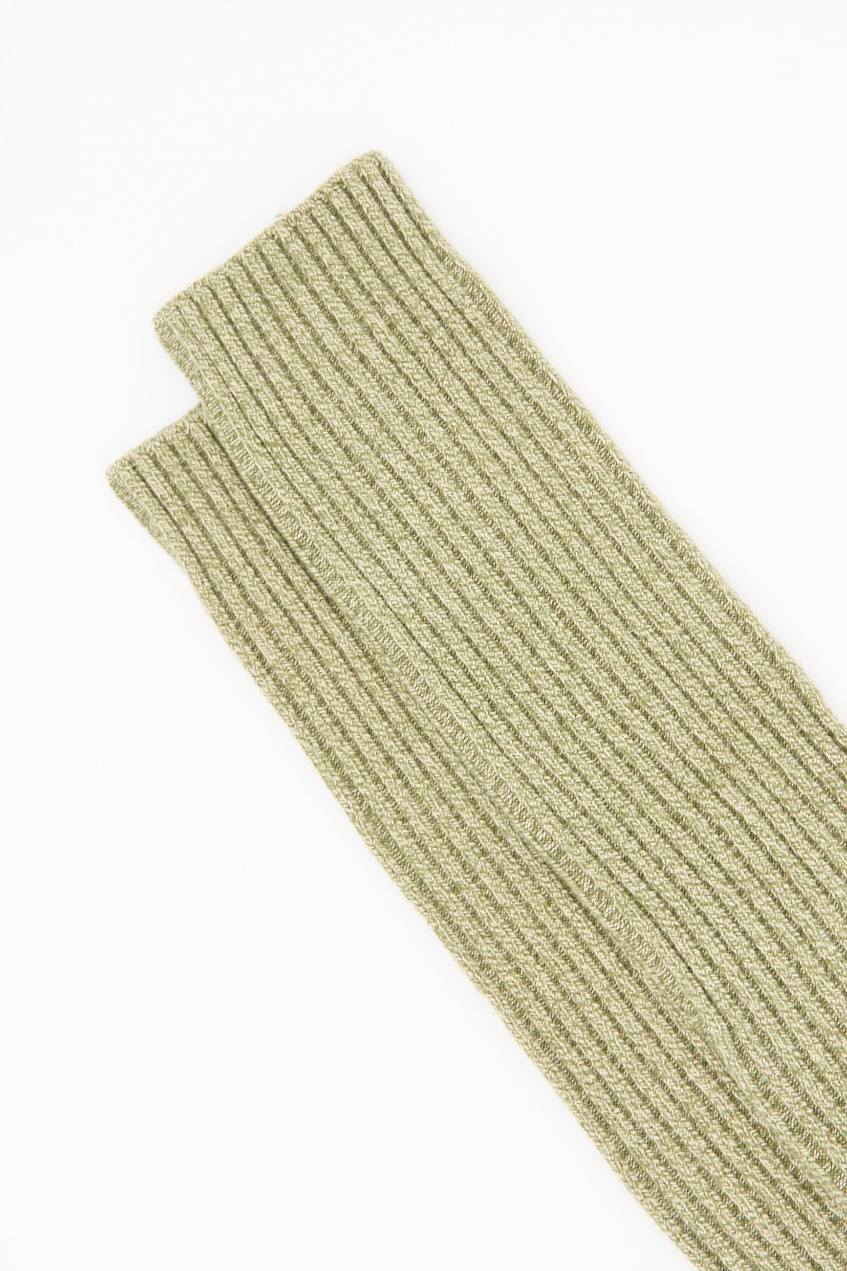 A close-up view of a folded, rib-knit Overknee Sock in Tre Green and Su Tan by Baserange on a white background, showcasing its intricate texture reminiscent of rib knit scarves.