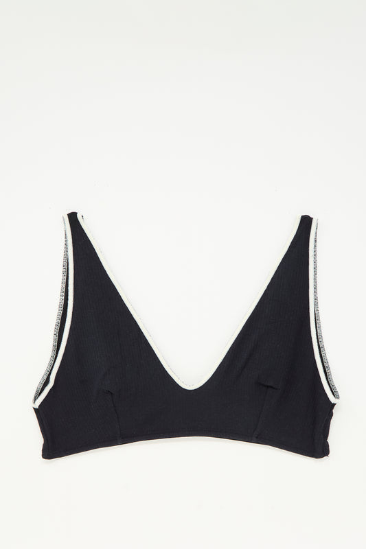 The Baserange Pam Bra in Murano Navy, featuring a v-neck and white trim, is shown laid flat on a white background.