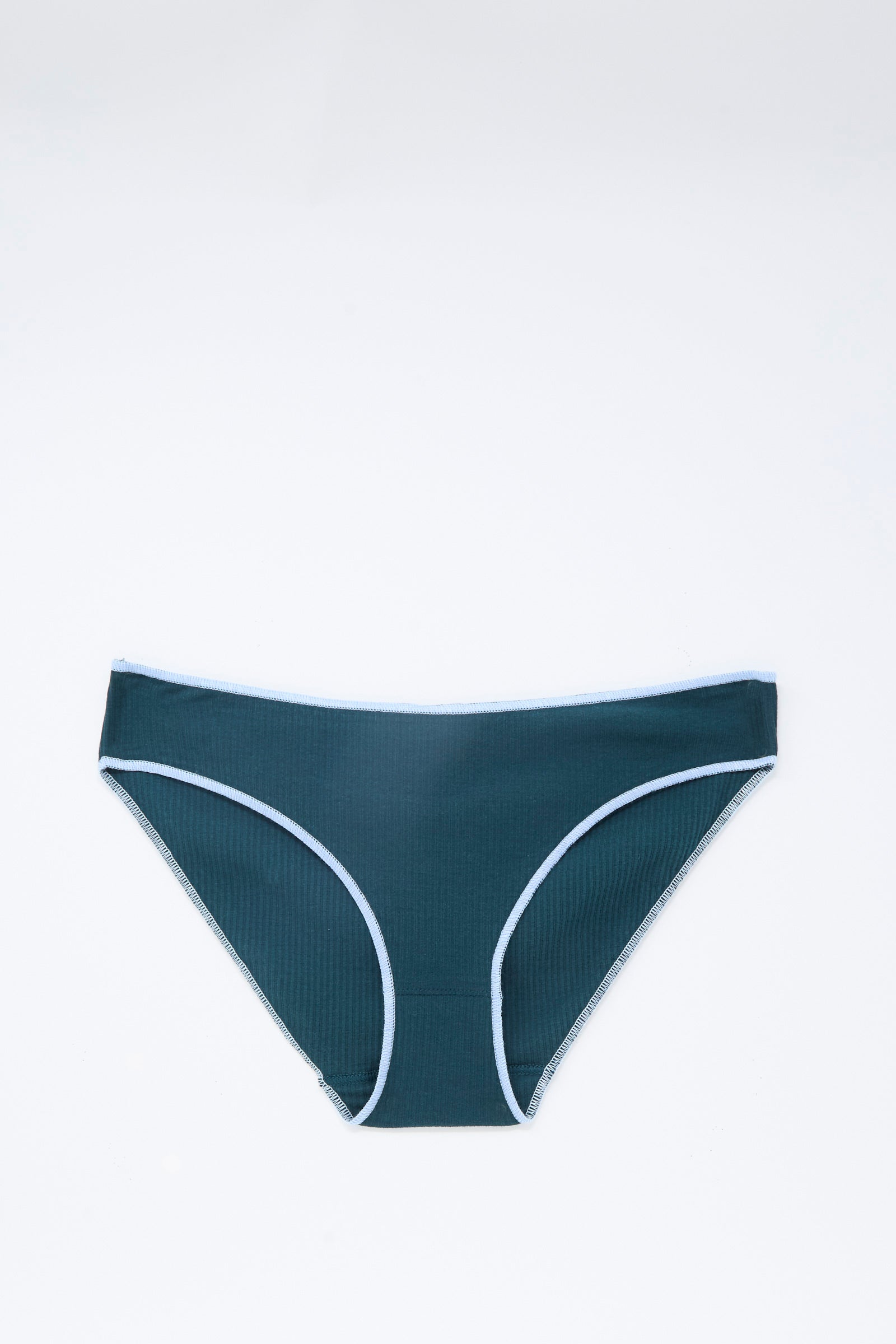 The Baserange Pam Pants in Hirsu Green are a pair of low-rise, brief bikini-style underwear featuring a dark green hue with light blue trim and an elastic waistband. Crafted from soft cotton rib fabric, they are shown laid flat against a plain white background.
