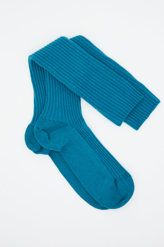 A pair of Baserange Rib Knee Socks in Sphere Blue, crafted from a soft cotton blend, laid flat on a white background.