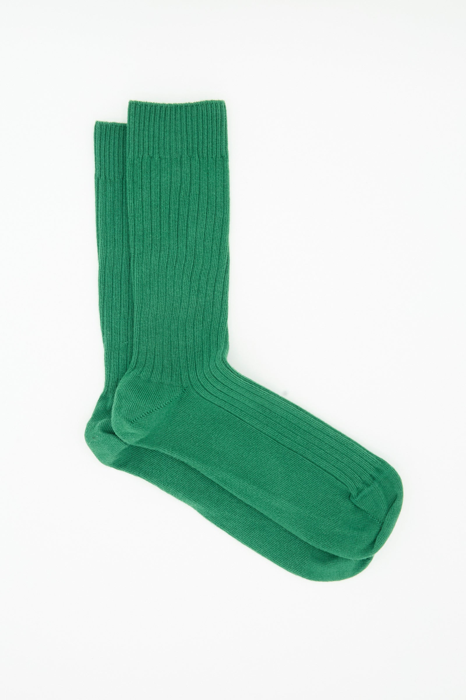 A pair of Baserange Rib Overankle Socks in Calla Green displayed side by side on a white background.