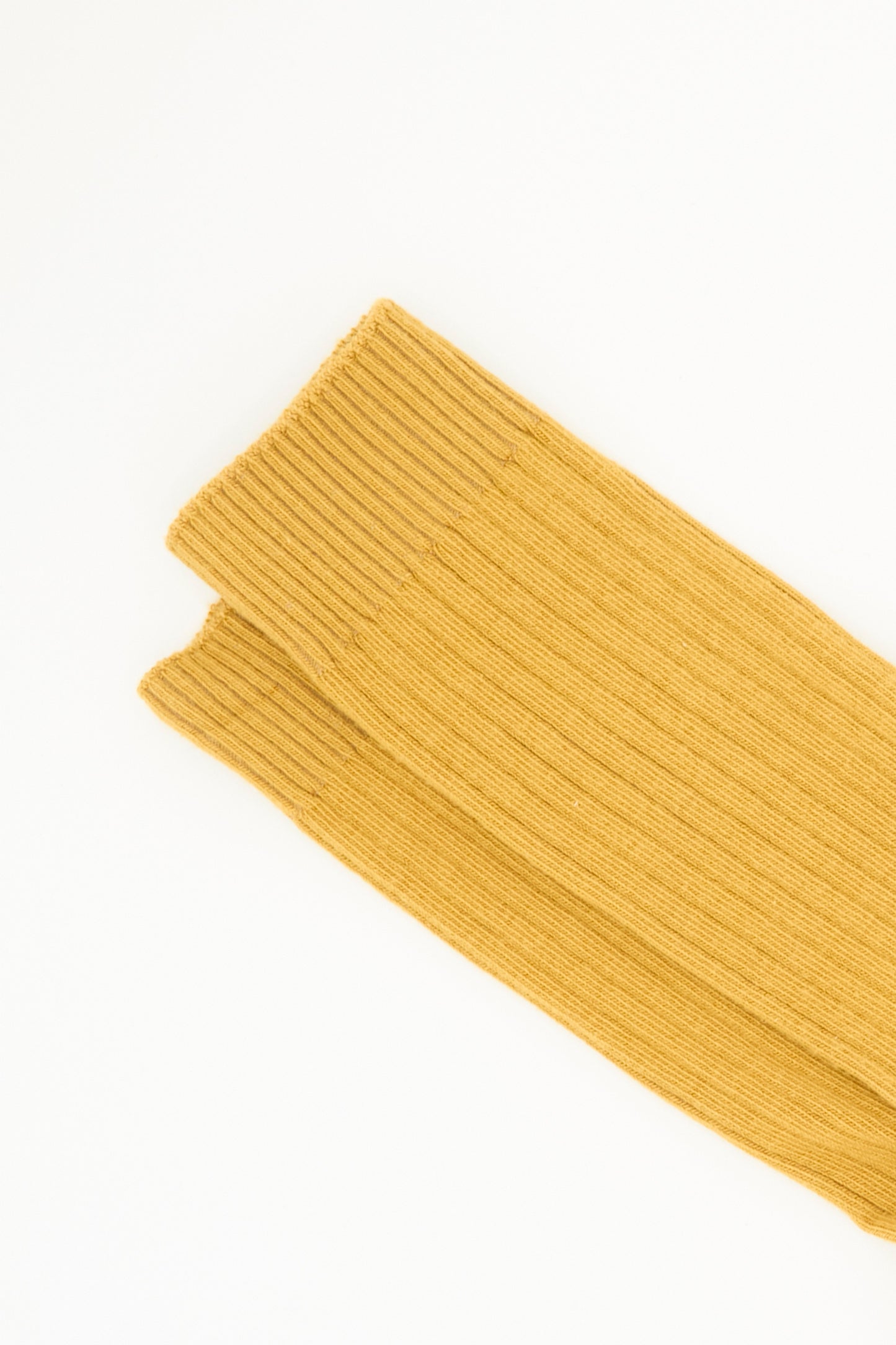 A pair of Baserange Rib Overankle Socks in Silva Brown is laid flat on a white background.