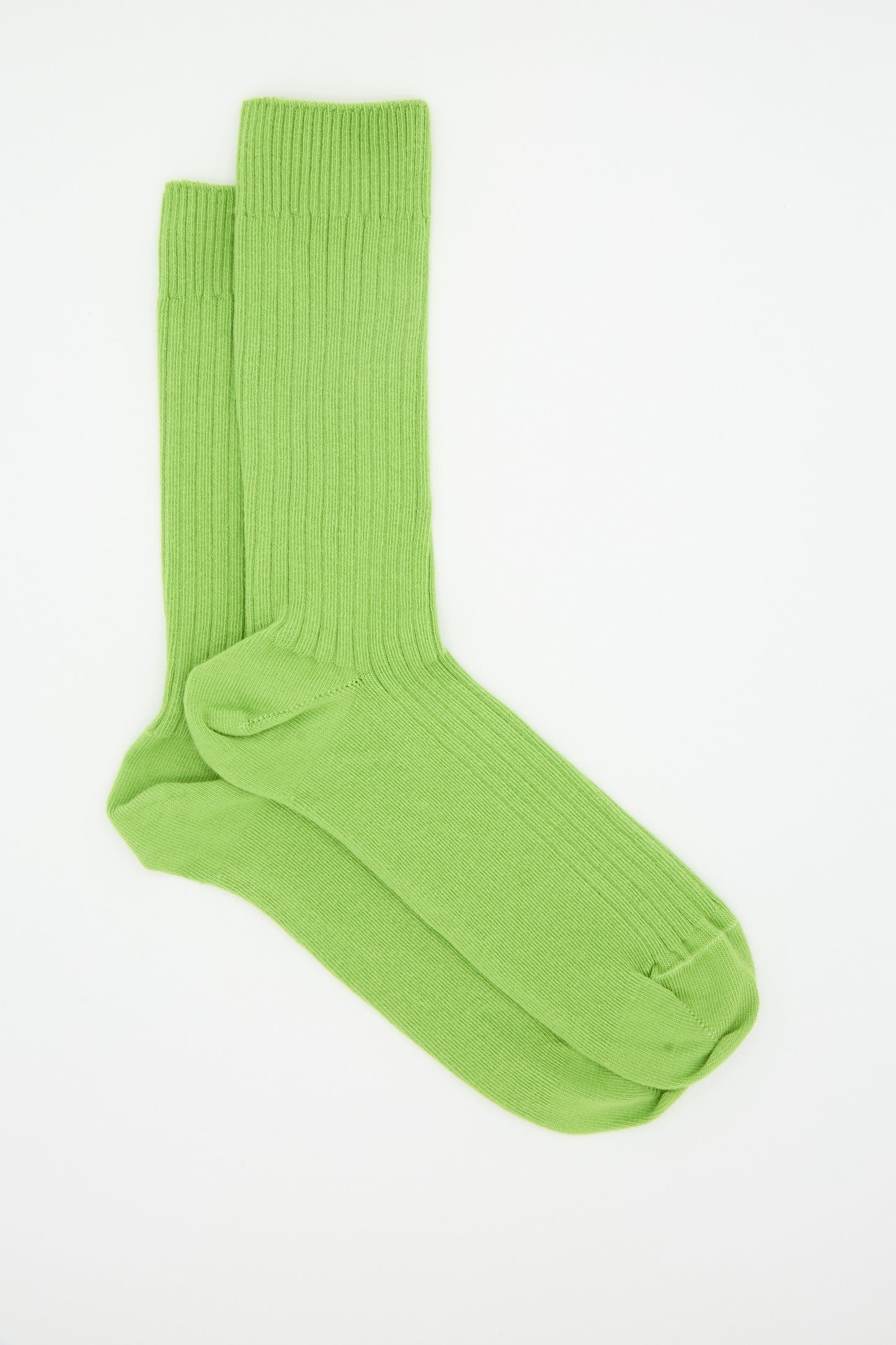 A pair of Baserange Rib Overankle Socks in Spiral Green, crafted from organic cotton, is neatly arranged on a plain white background.