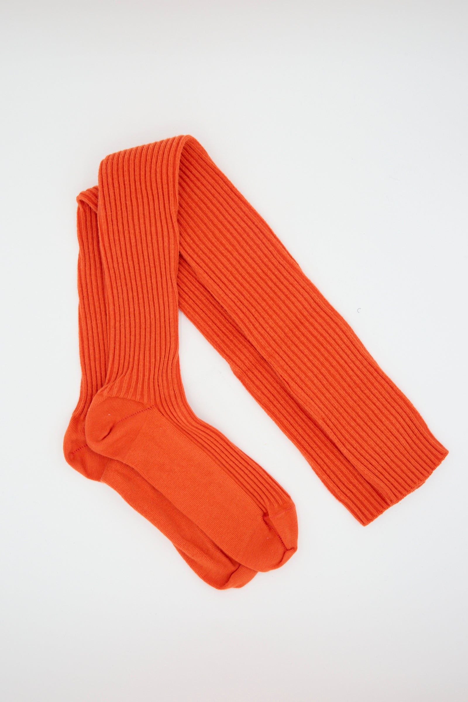 A pair of Baserange Rib Overknee Socks in Bill Red is laid flat on a white background.