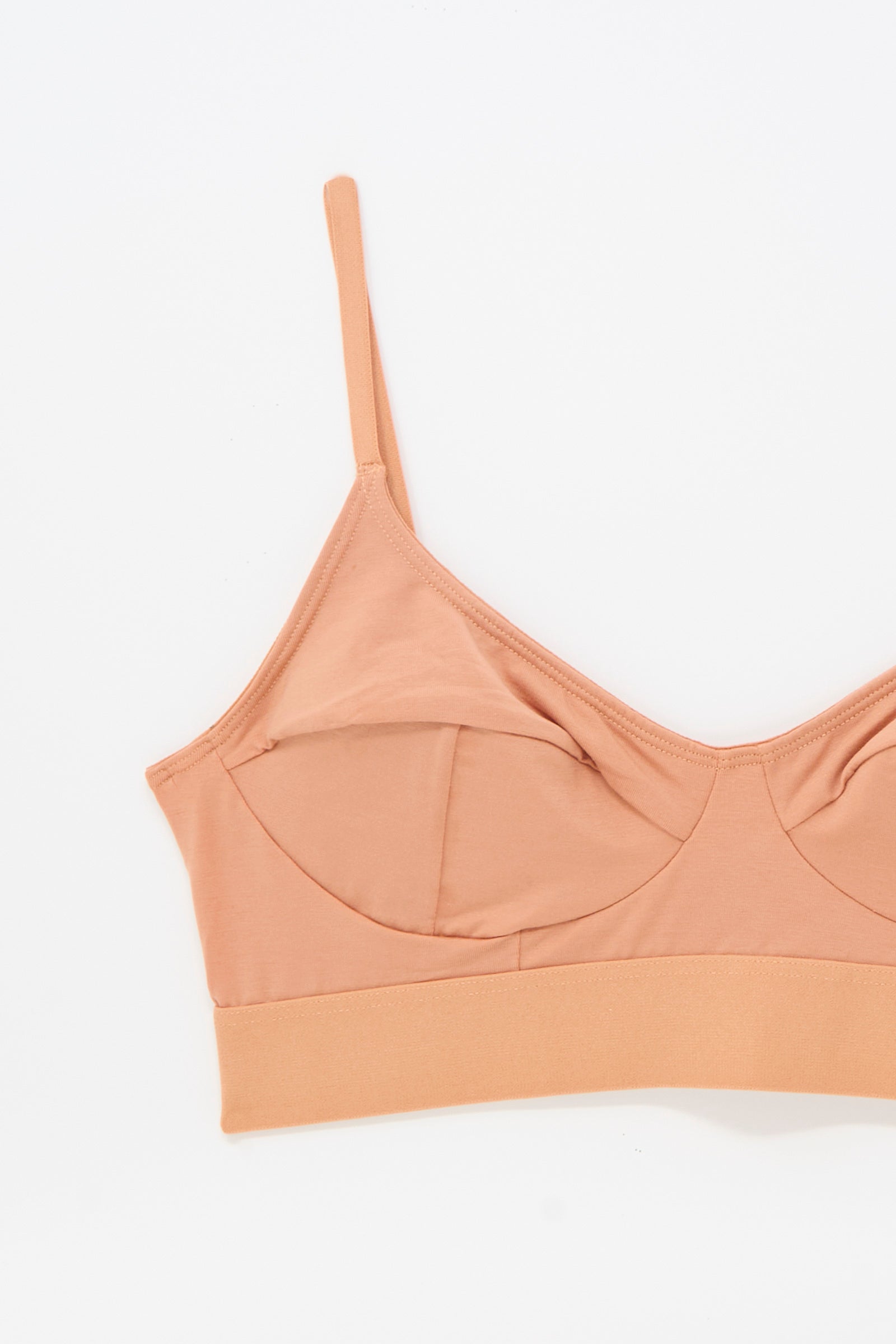 The Baserange Soft Bra in Branch Terracotta is a light brown, wireless bamboo jersey bra featuring thin adjustable straps and a wide elastic band, shown on a white background.