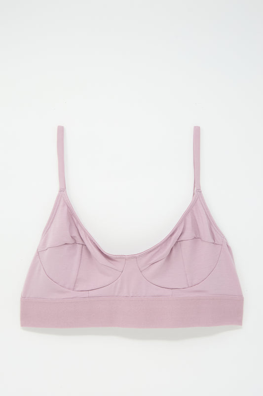 Light pink bralette made from soft bamboo jersey, featuring supportive seamed cups, thin adjustable straps, and a wide underband, laid flat on a white background.

Let’s revise this with the given product name and brand name:

Soft Bra in Still Purple by Baserange made from soft bamboo jersey, featuring supportive seamed cups, thin adjustable straps, and a wide underband, laid flat on a white background.