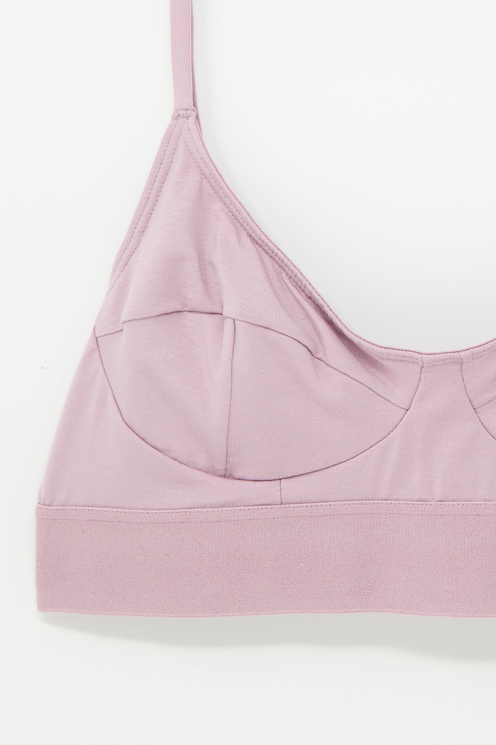 A close-up image of the Baserange Soft Bra in Still Purple featuring supportive seamed cups, adjustable straps, and an elastic underband.