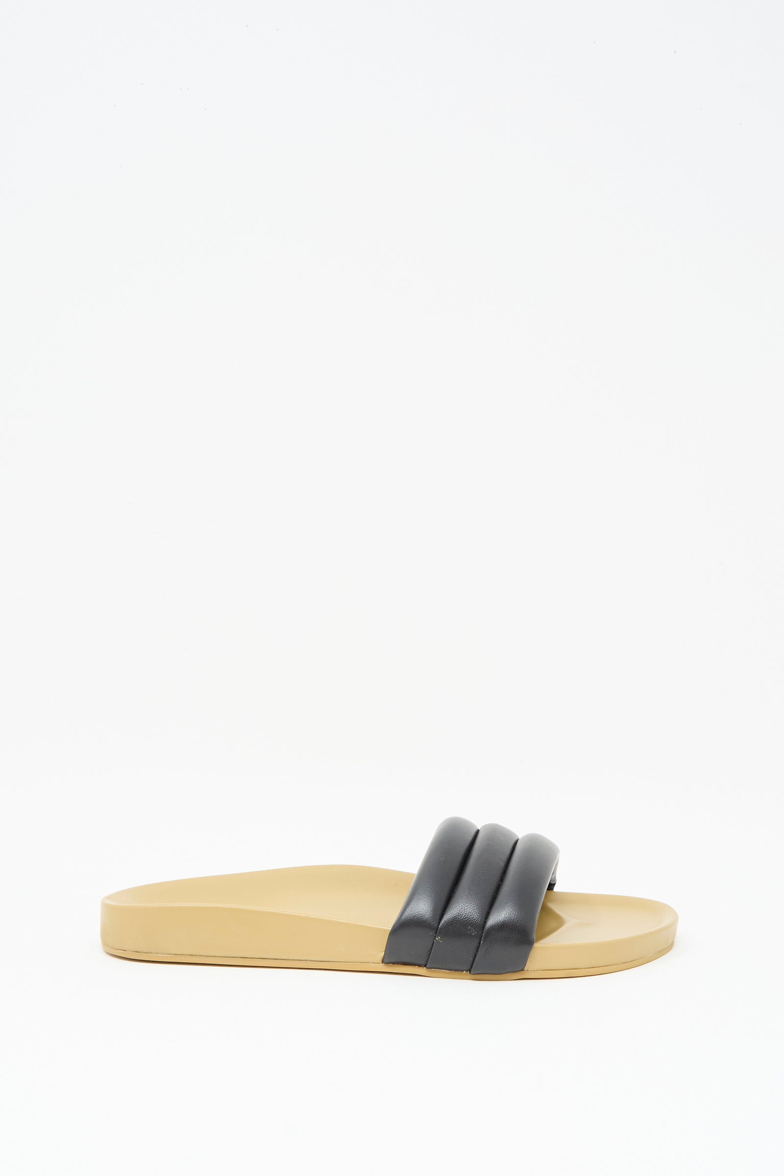 The Classic Sandalia in Black by Beatrice Valenzuela features black, padded lambskin double straps and a beige leather flat sole, shown against a white background.