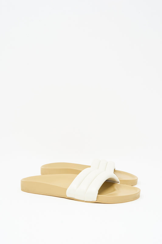 The Beatrice Valenzuela Classic Sandalia in Shell features handcrafted beige slide sandals with a padded white strap, showcased on a plain white background.