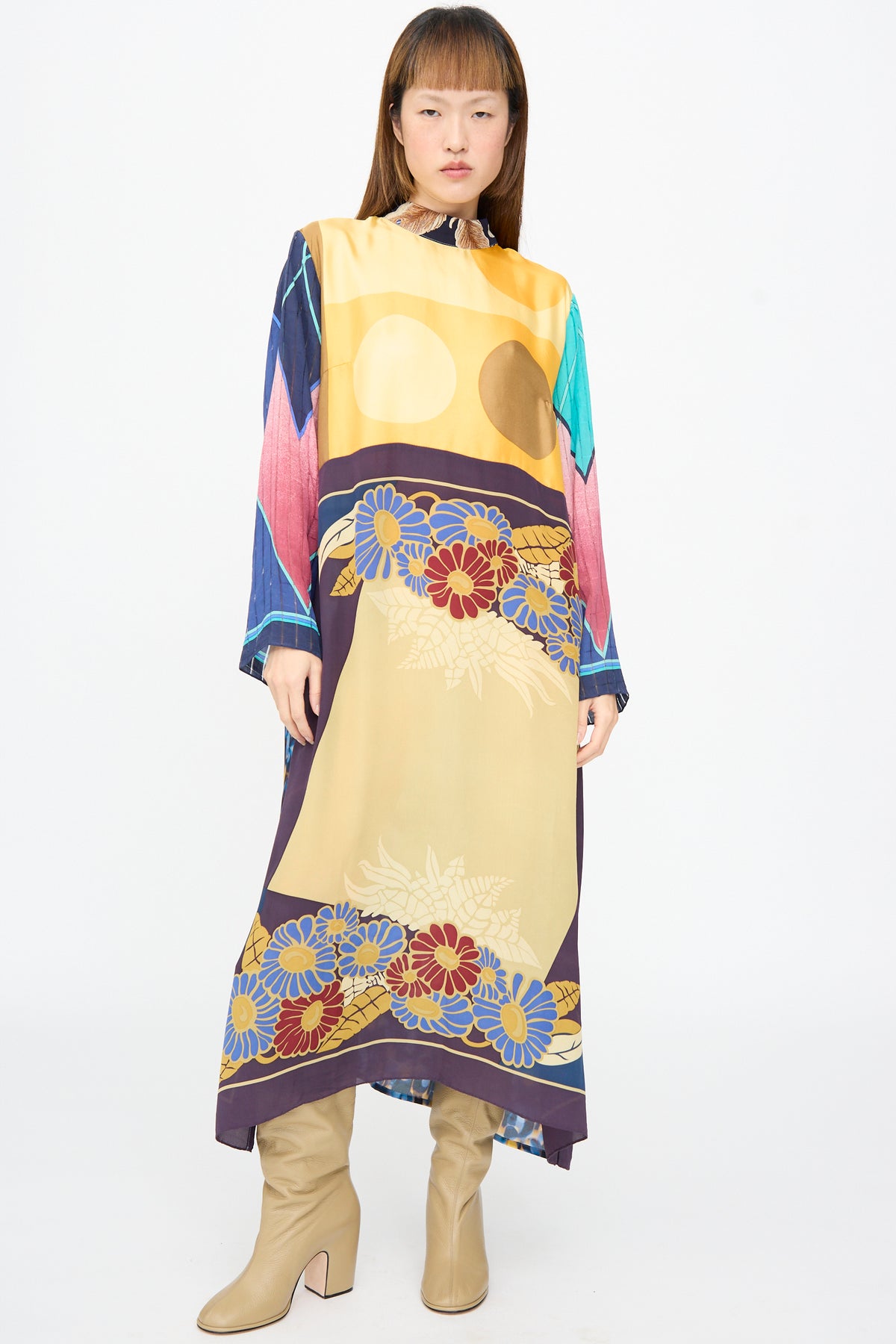 Bettina Bakdal Classic Mandarin Collar Dress in Alice Vollmer, an up-cycled silk dress with a mandarin collar, multi-colored floral and geometric print, paired with tan heeled boots.