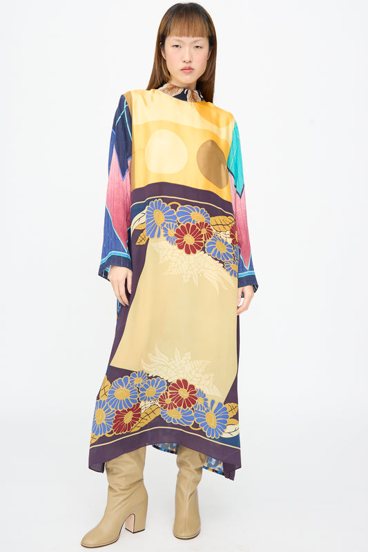Bettina Bakdal Classic Mandarin Collar Dress in Alice Vollmer, an up-cycled silk dress with a mandarin collar, multi-colored floral and geometric print, paired with tan heeled boots.