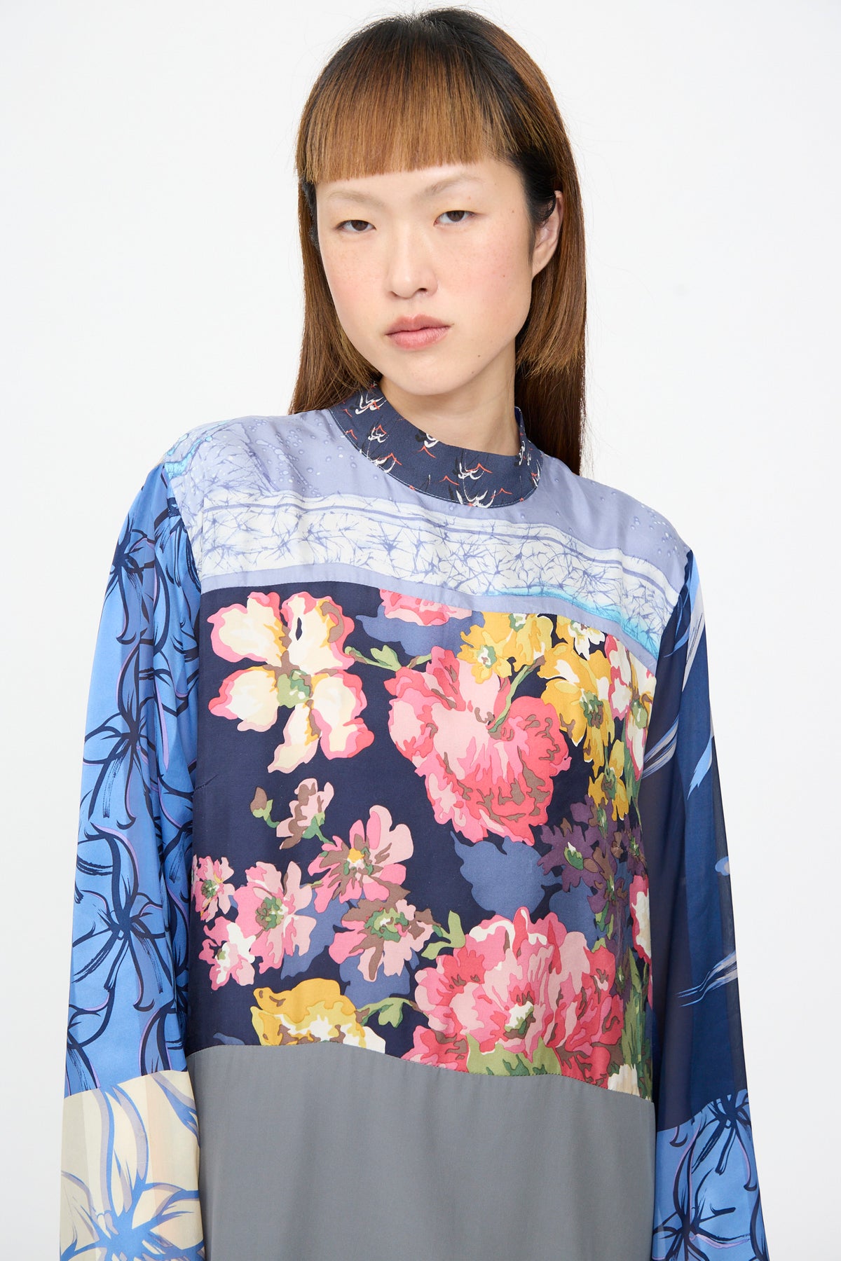 Bettina Bakdal Classic Mandarin Collar Dress in Grete Willers, an up-cycled silk long-sleeved dress with a color-blocked floral print in shades of blue, pink, and grey.