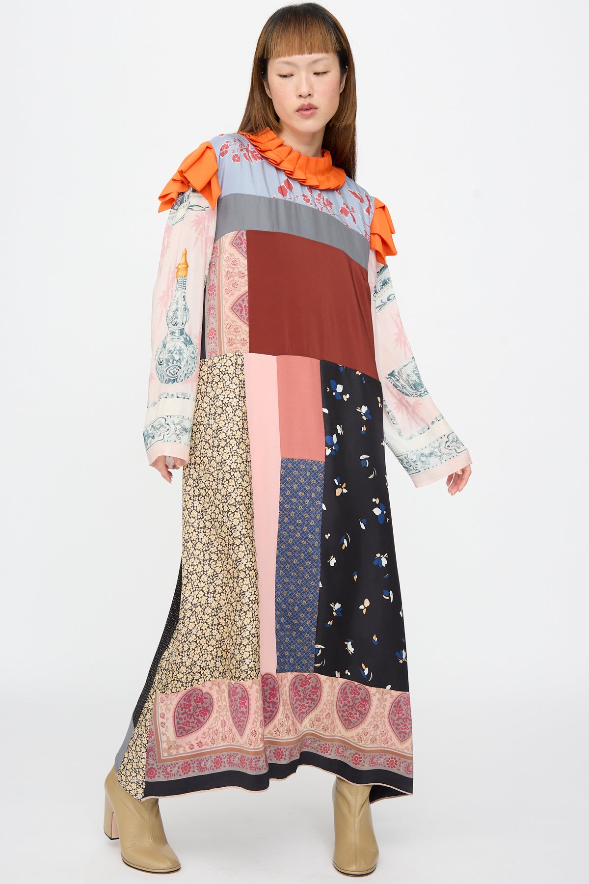 Bettina Bakdal Ruffled Collar and Shoulder Dress in Grit Kallin, a long, up-cycled silk dress with a ruffled orange collar and shoulders, featuring patchwork floral and abstract vintage silk scarves.