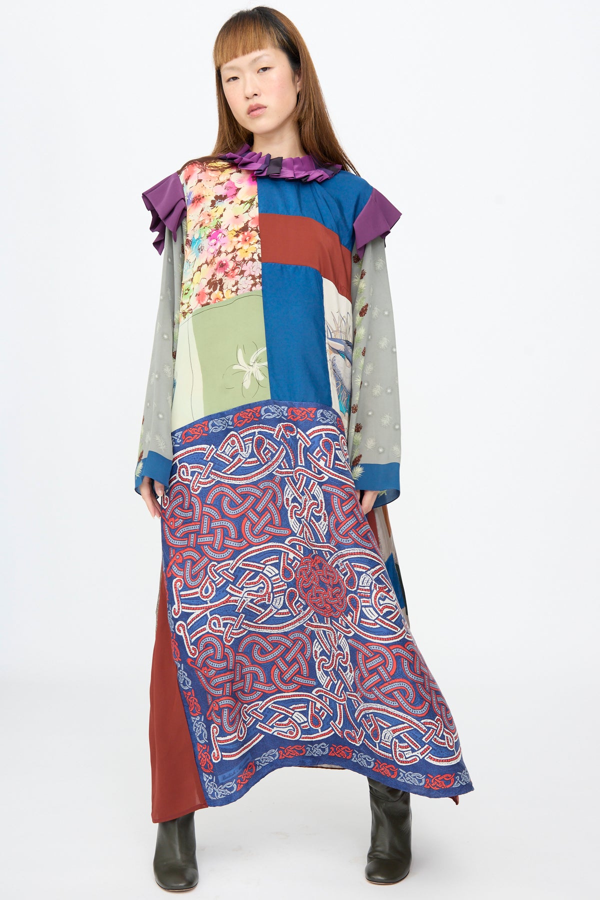 Bettina Bakdal Ruffled Collar and Shoulder Dress in Ilse Fehli, a long-sleeve dress with a purple ruffled collar and shoulders, featuring an up-cycled patchwork of silk floral, solid, and knotwork panels.