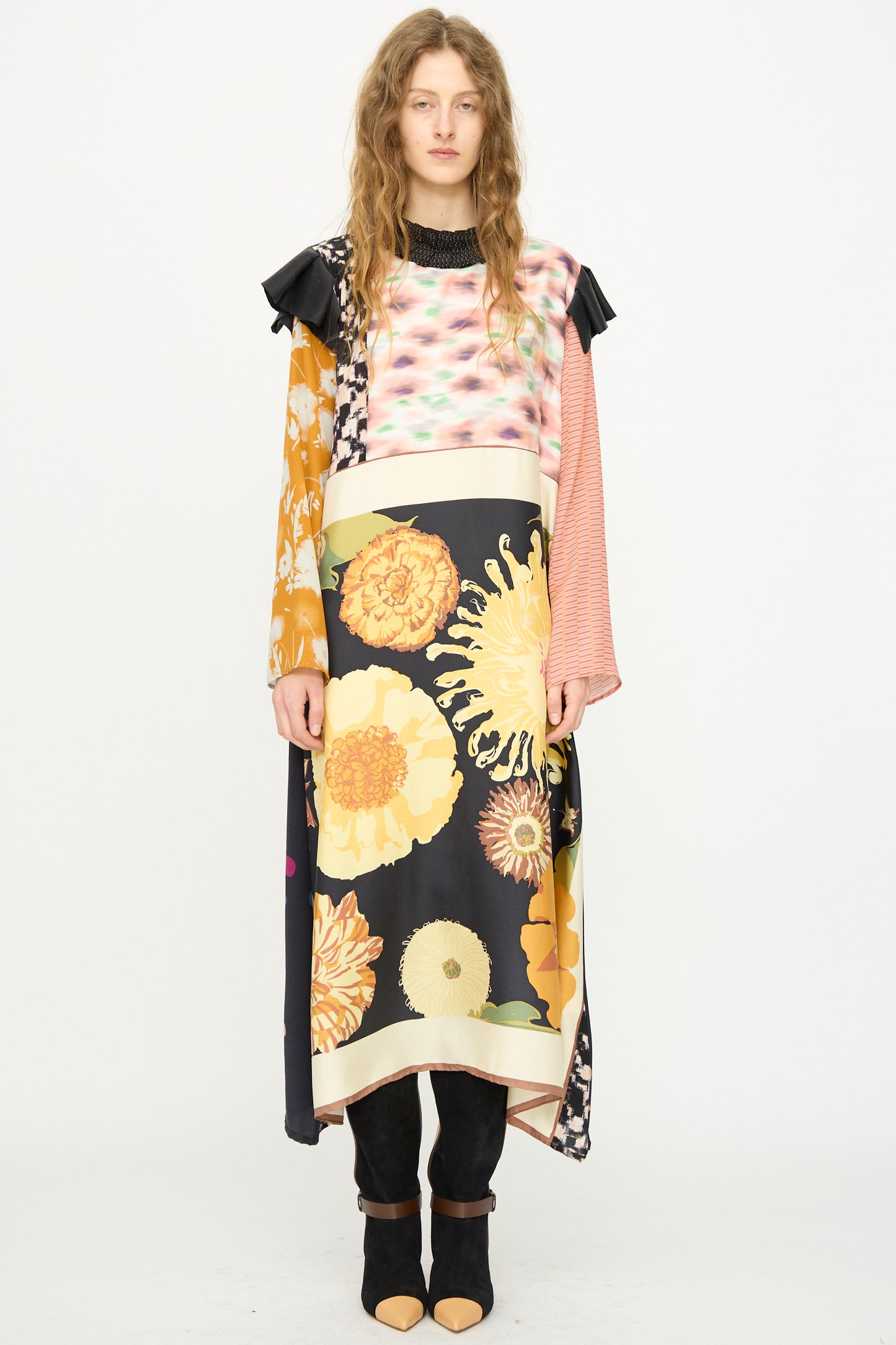 A woman stands against a white background wearing the Bettina Bakdal Ruffled Collar and Shoulder Vintage Scarves Dress in Edith Suschitzky.