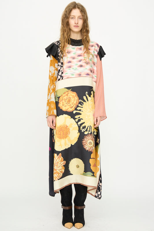 A woman stands against a white background wearing the Bettina Bakdal Ruffled Collar and Shoulder Vintage Scarves Dress in Edith Suschitzky.