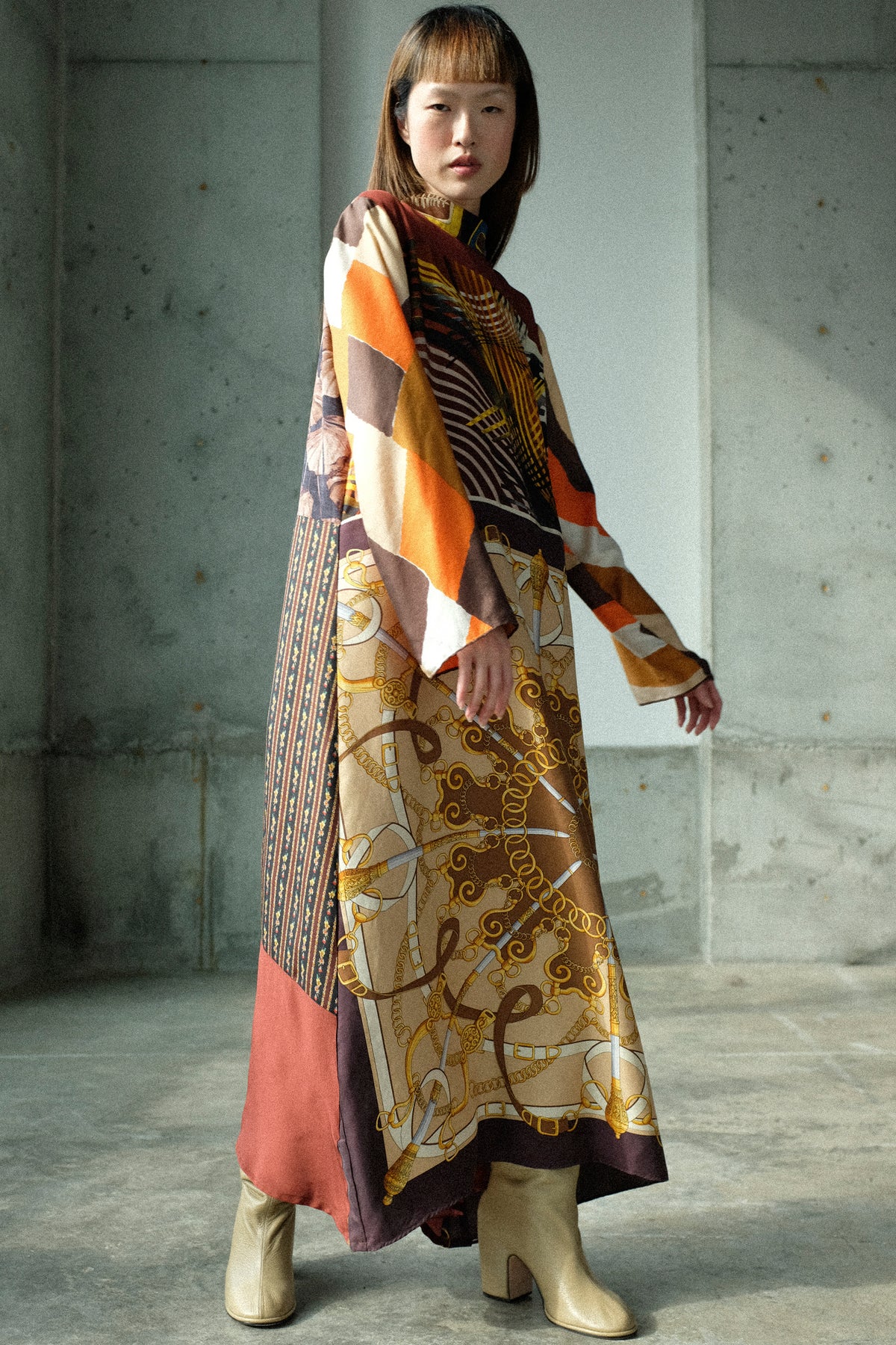 A woman standing in a studio wearing Bettina Bakdal's Classic Mandarin Collar Dress in Benita Otte.