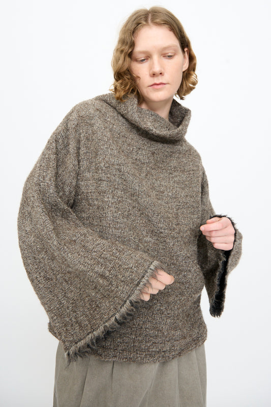 Person wearing the Alpaca Tube Top in Beige by Black Crane, standing against a plain white background.