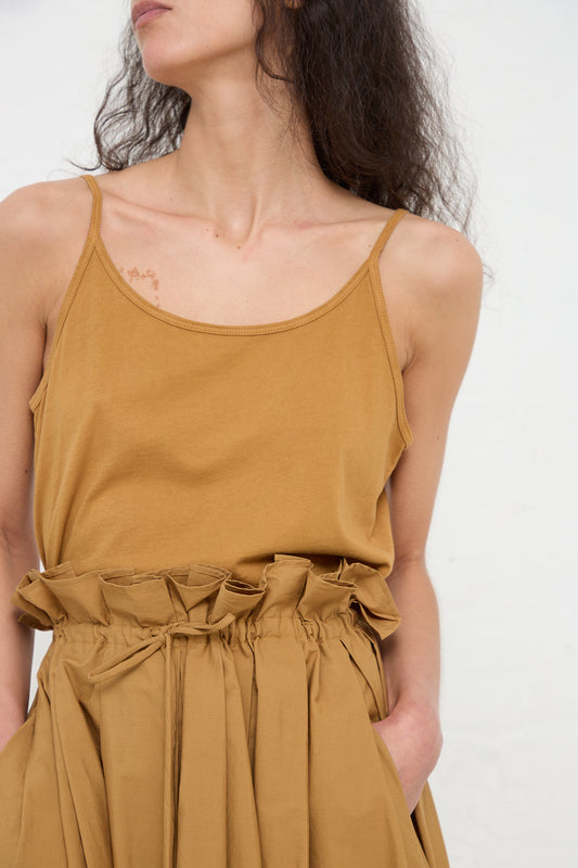 Woman wearing a Black Crane Organic Cotton Jersey Camisole in Camel and matching skirt.