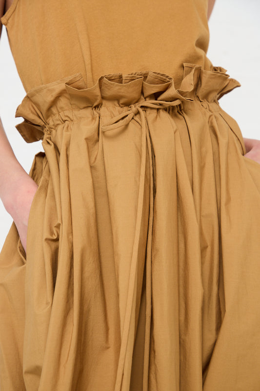 Close-up of a Black Crane Cotton Parachute Skirt in Camel with gathered ruffle detail.