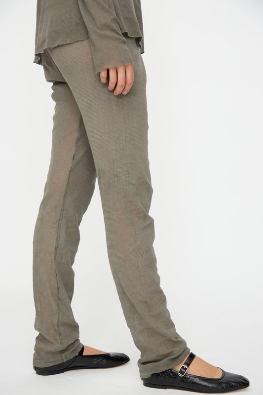 A person wearing Black Crane Mesh Leggings in Dark Stone—an easy alternative to slim fits—paired with black flats, stands against a plain white background. Only the lower half of the body is visible.