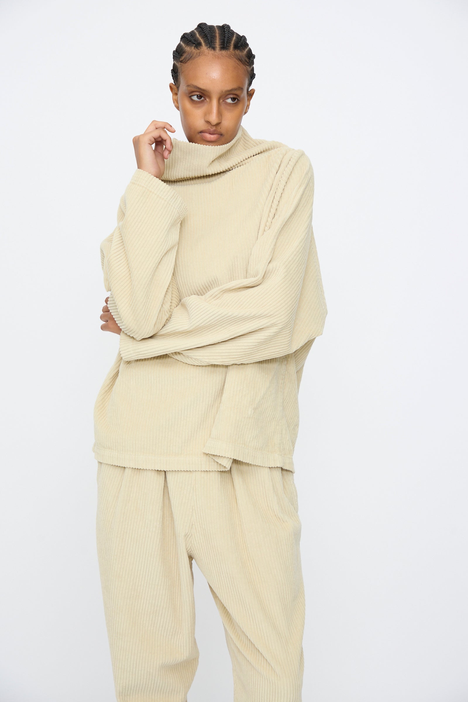 A person wears the Black Crane Tube Top in Ivory, styled with matching pants, standing against a plain white background.