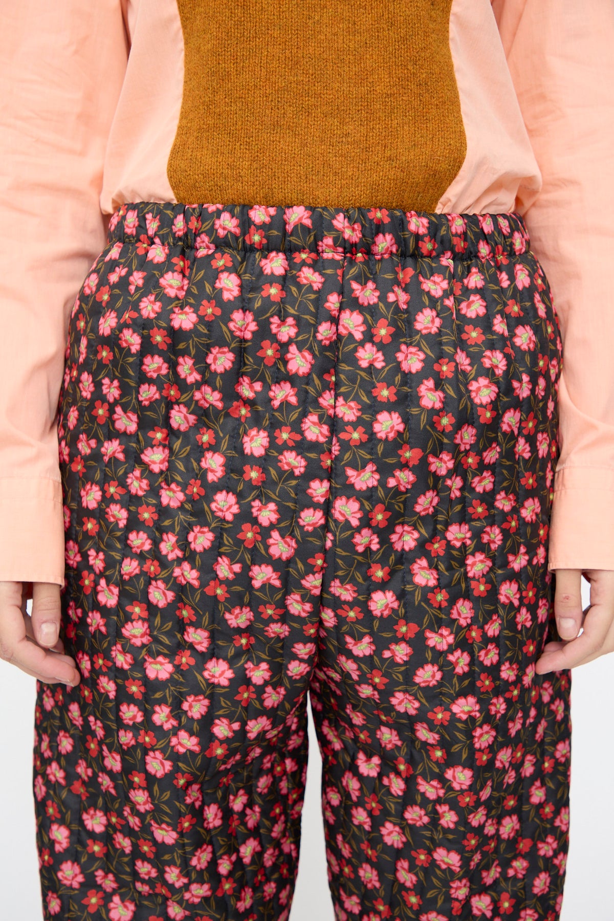 Bless No. 08 Monpe Pants in Floral Print V, featuring quilted black nylon with an all-over pink and red floral print.