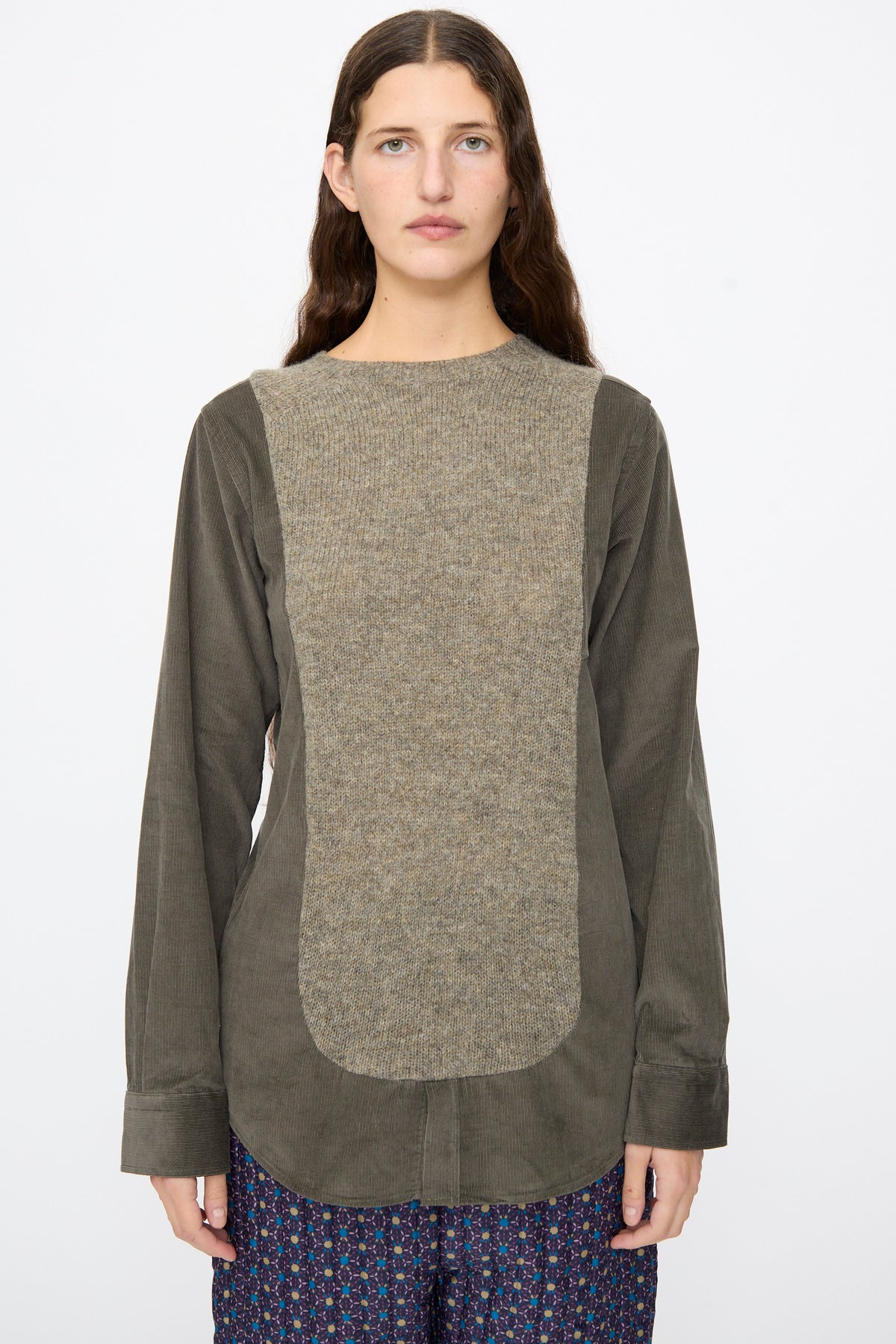 A person wearing the Bless No. 68 Frontinsertpullover in Unique III, featuring a wide, textured light-brown corduroy front panel with olive-green sleeves and back.