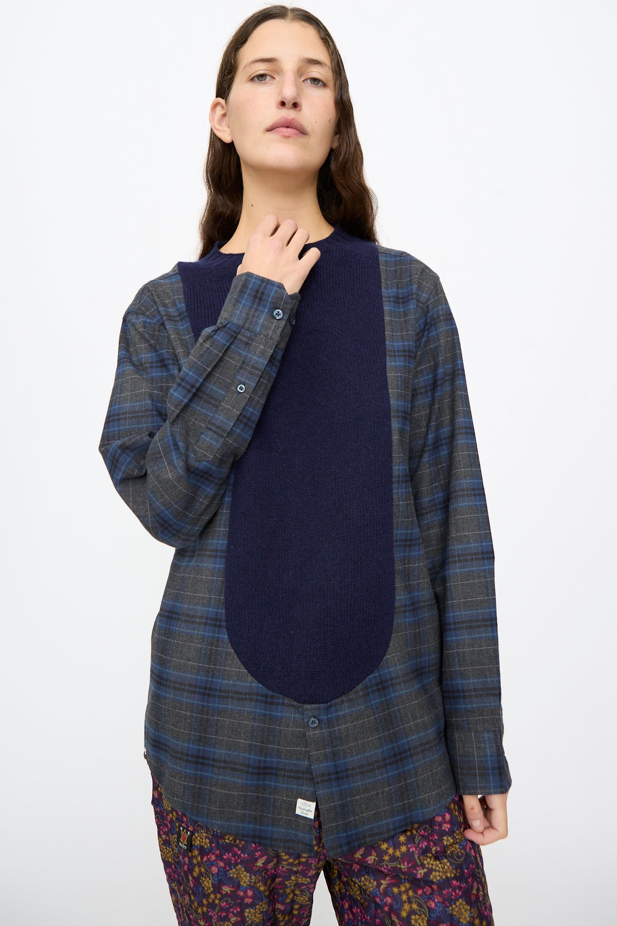 Person wearing a Bless No. 68 Frontinsertpullover in Unique IV, a flannel shirt with a solid navy knit panel inserted down the front.