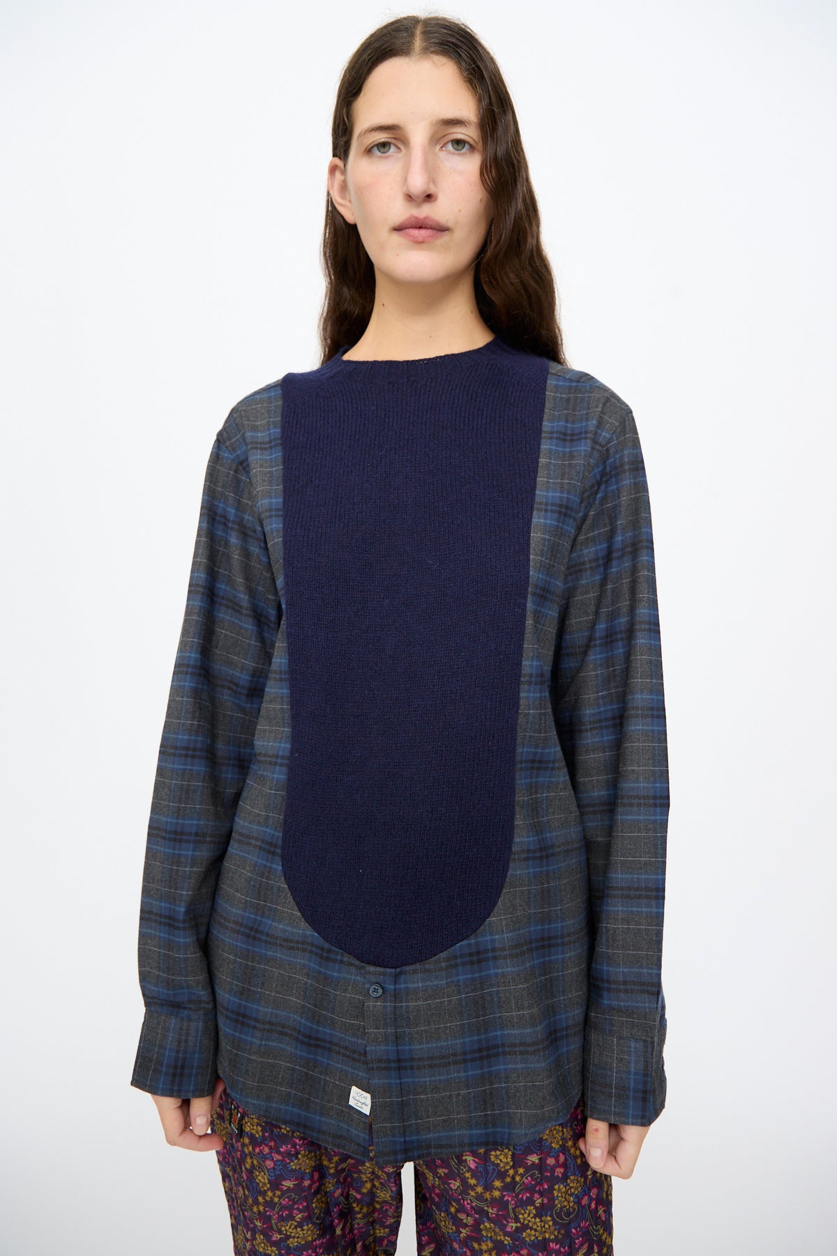 Bless No. 68 Frontinsertpullover in Unique IV: a long-sleeved shetland wool pullover featuring a large, solid navy blue knit panel centered over a blue and grey flannel shirt.