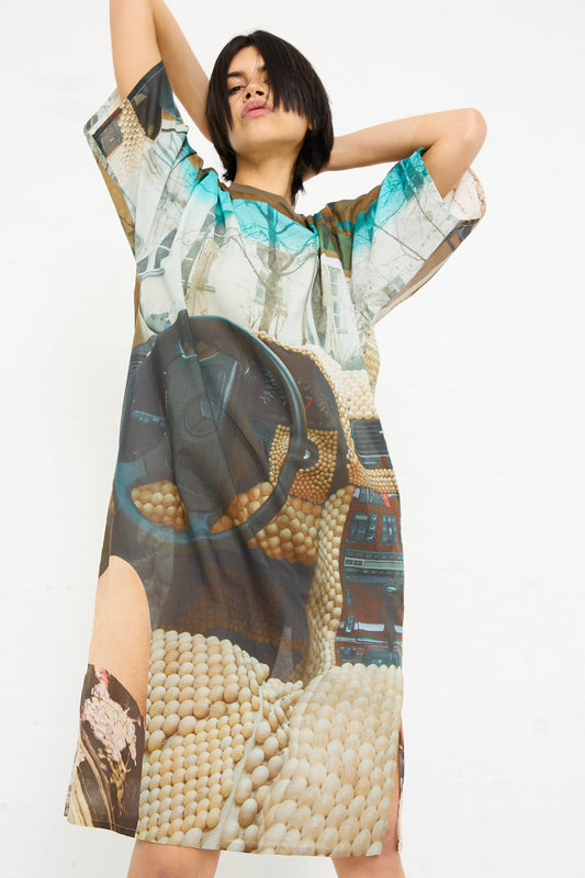 Woman in a Bless No. 77 Sauna Rider Holiday Dress in Print with a graphic print posing with her hands behind her head against a white background.