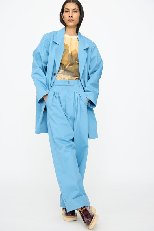 A model wears the Bless No. 81 Summer Workcoat Short in Skyblue against a plain white background.