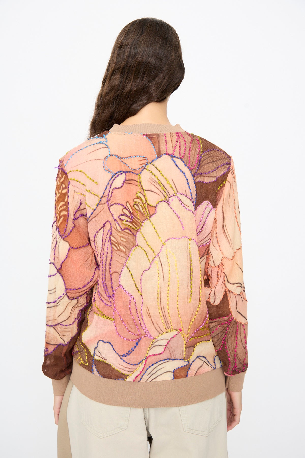 Back view of the Bless No. 82 Embroidered Sweater in Multicolor Beige and Rosé, a lightweight, long-sleeved crewneck featuring a large, abstract floral pattern outlined with colorful contrast stitching.