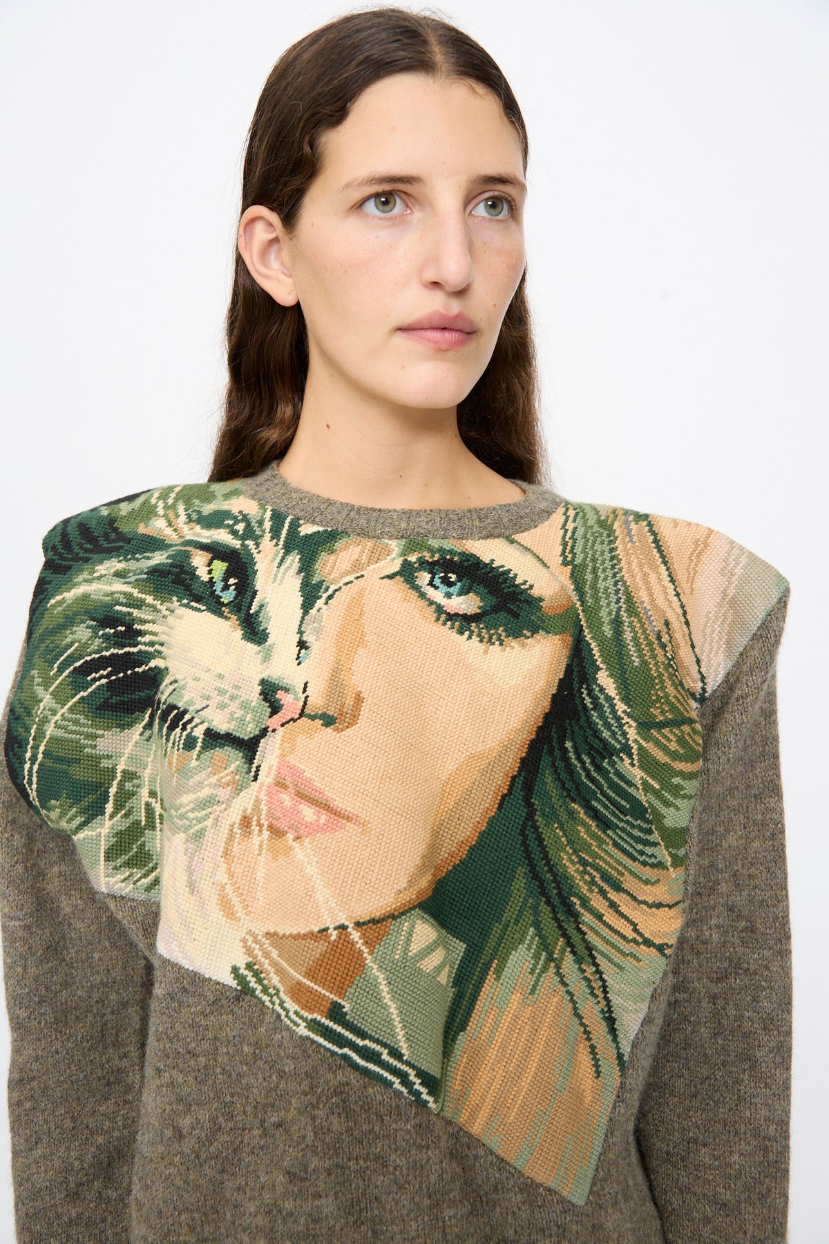 The Bless No. 82 Kitschenrich in Unique Ultralarge Patchwork I is a brown wool pullover sweater featuring a large needlepoint motif of a woman’s face combined with a cat’s face across the chest.