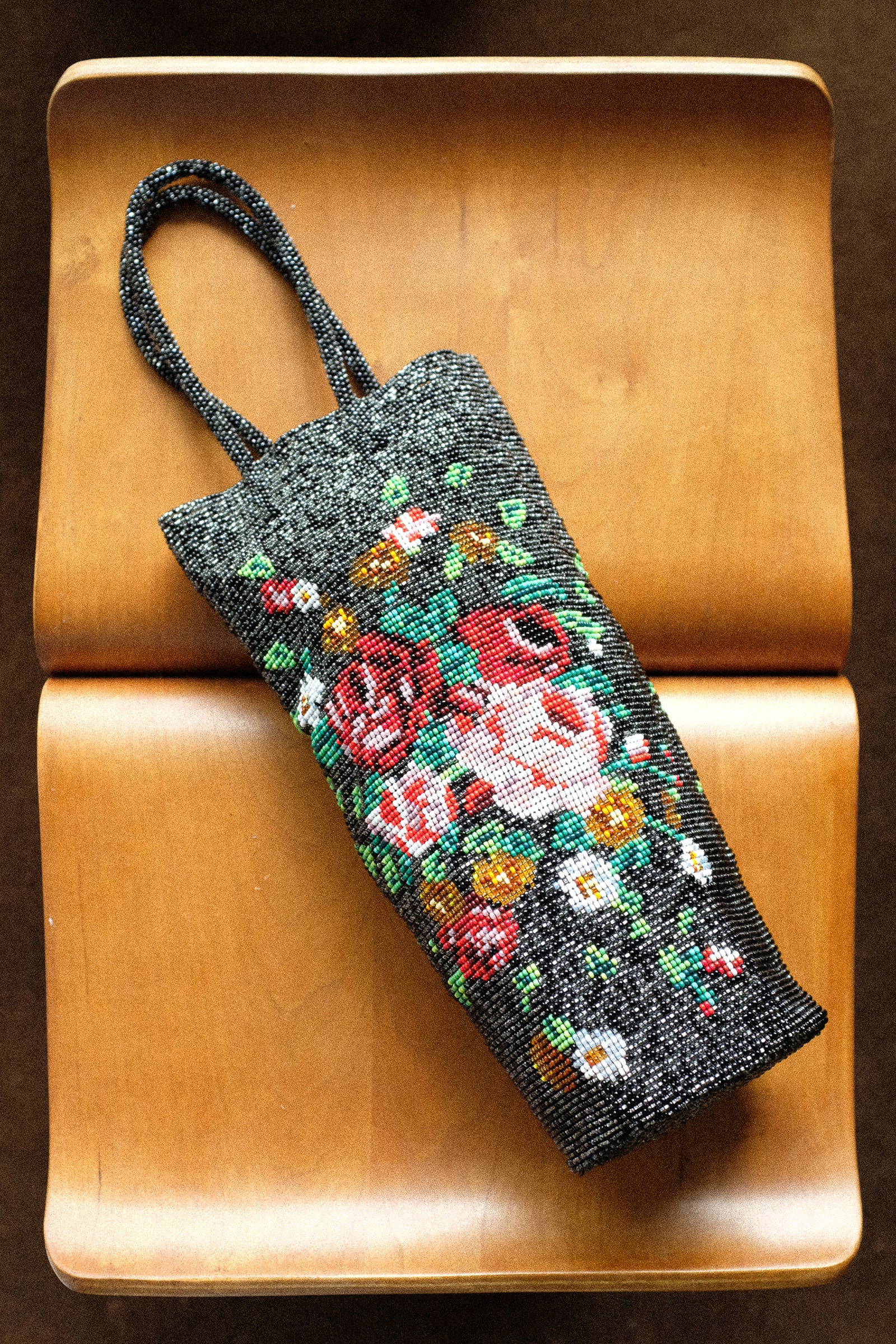 Cordera's Beaded bag on a wooden stool.