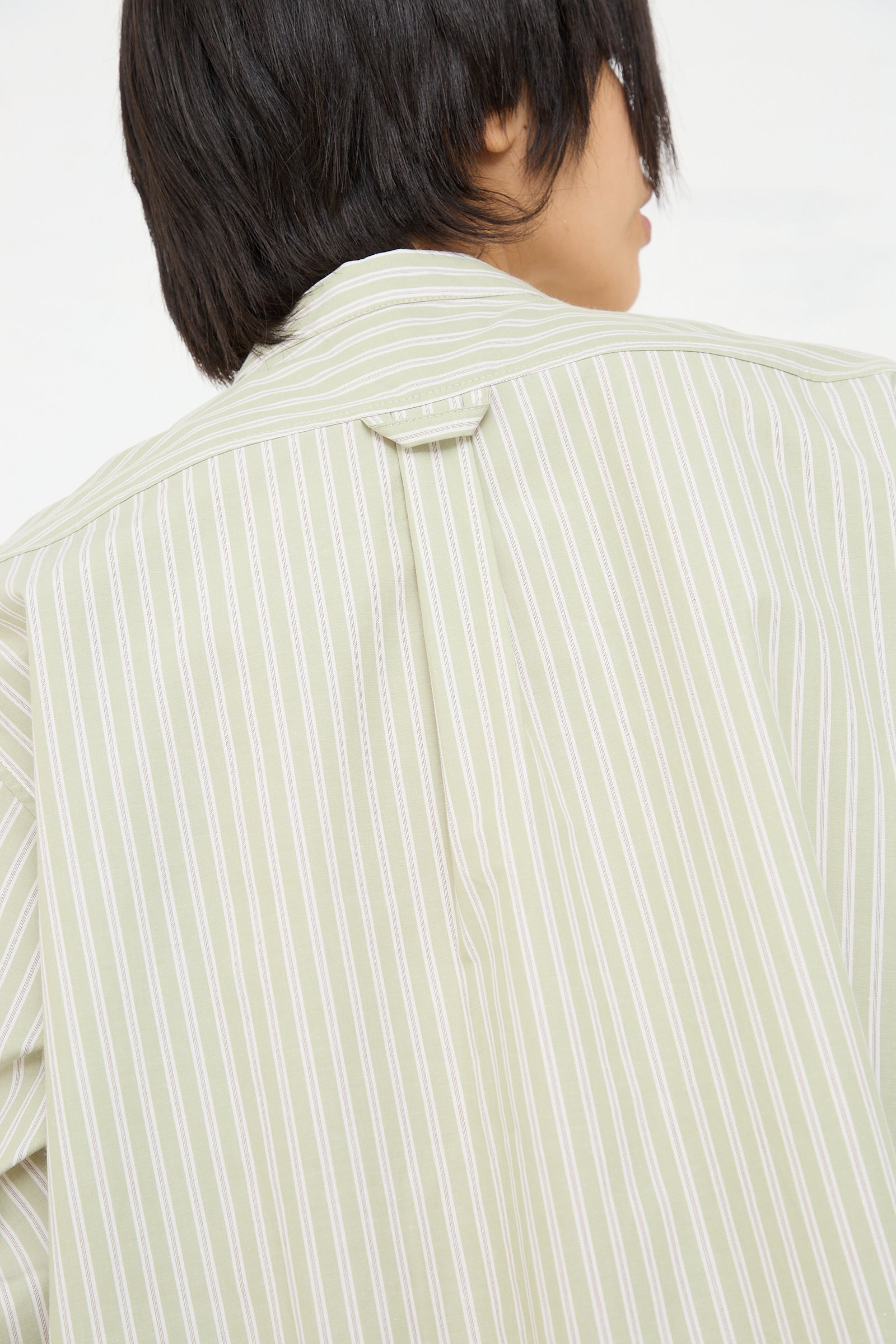 Rear view of a person wearing a Cawley Japanese Cotton Ines Shirt in Mint and Ecru.