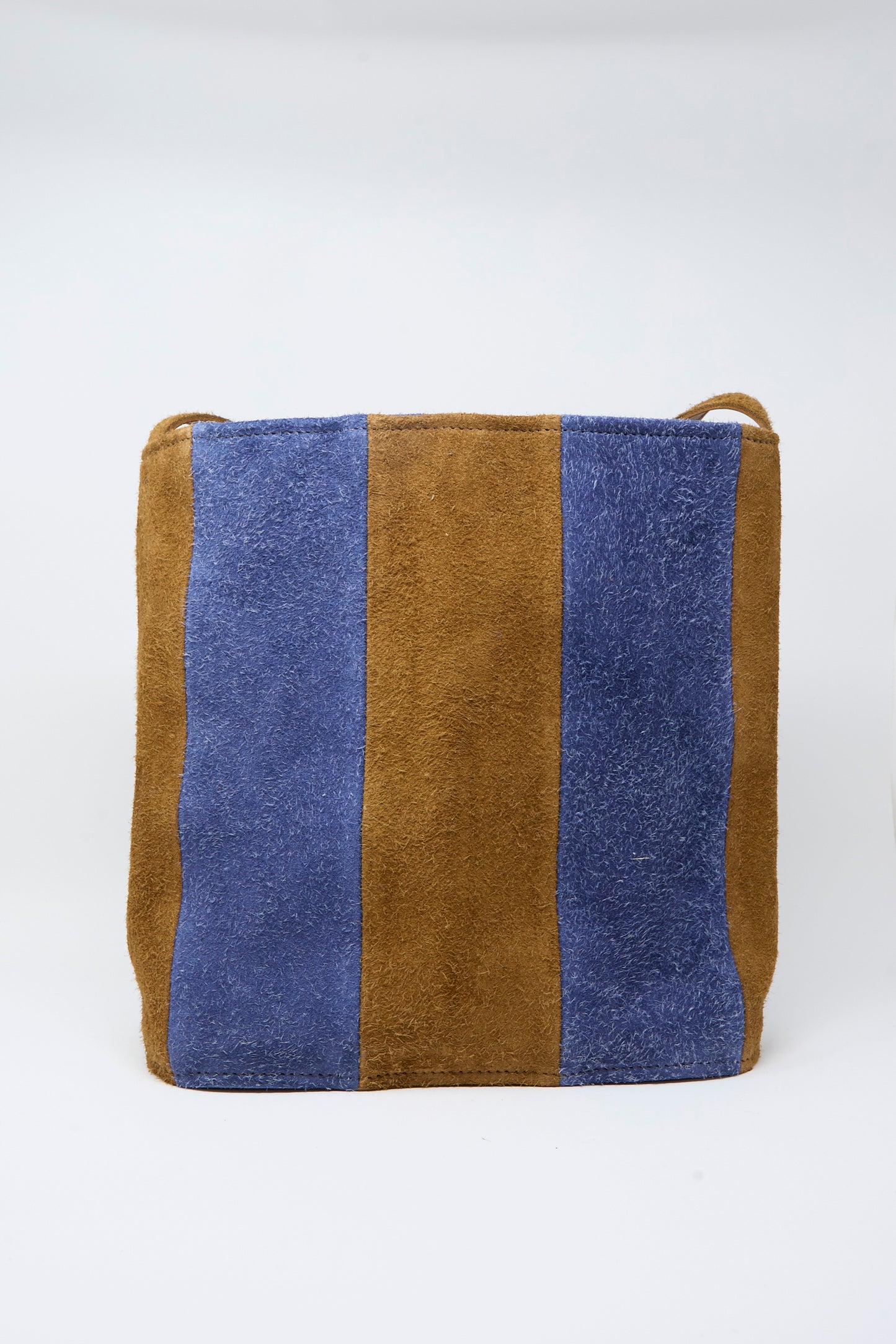 The Cawley Suede Striped Shoulder Bag in Navy and Light Brown, crafted in the UK, features a square leather silhouette with vertical navy and light brown suede stripes and is photographed against a plain white background.