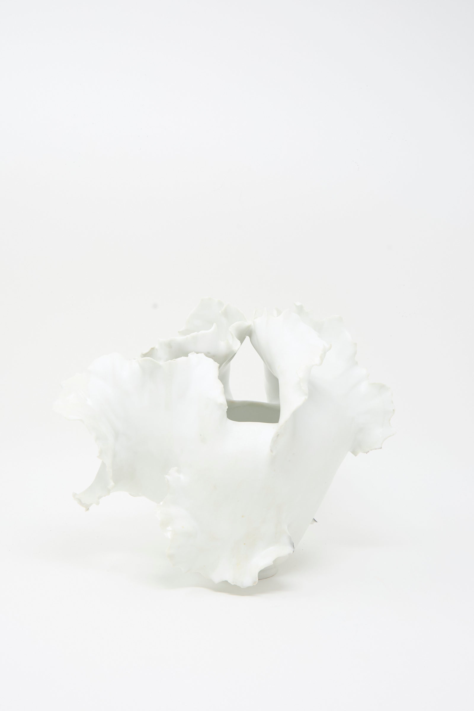 Roots N3 Sculpture in White by Chala Toprak—an artisanal white porcelain piece with an irregular, wavy-edged form reminiscent of sculpted clay—displayed against a plain white background.