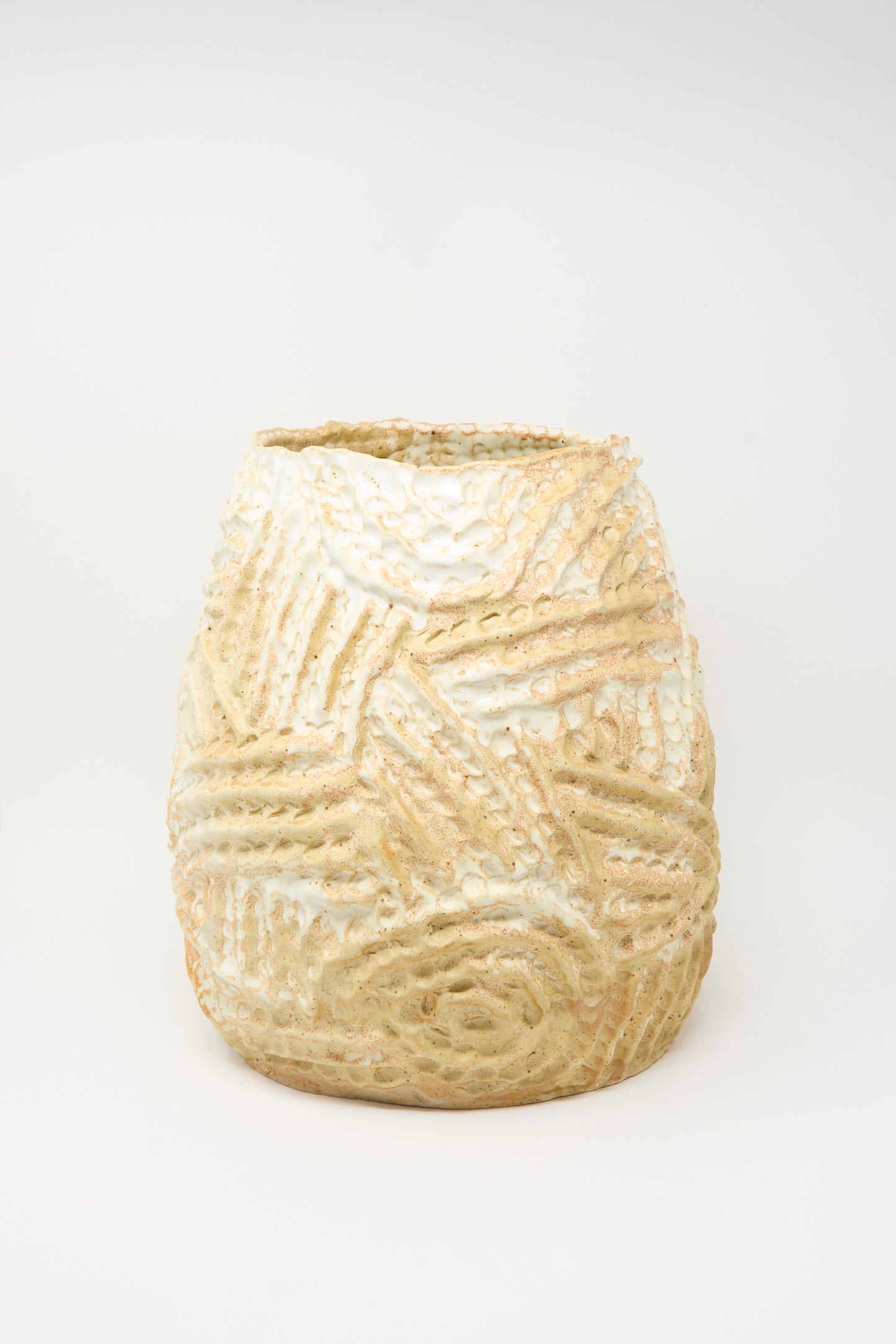 A large, hand-built ceramic vase in yellow with a raised ridge pattern by Claire Resnick Ceramics, photographed on a plain white background.