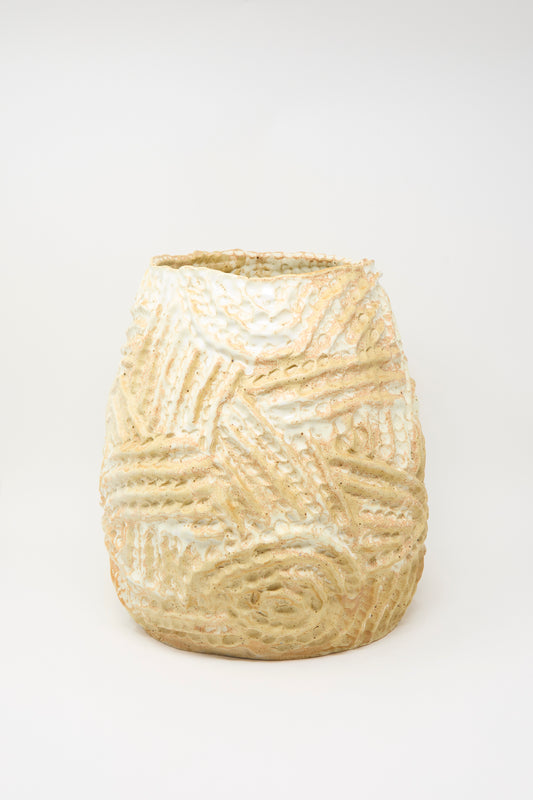 A large, hand-built ceramic vase in yellow with a raised ridge pattern by Claire Resnick Ceramics, photographed on a plain white background.