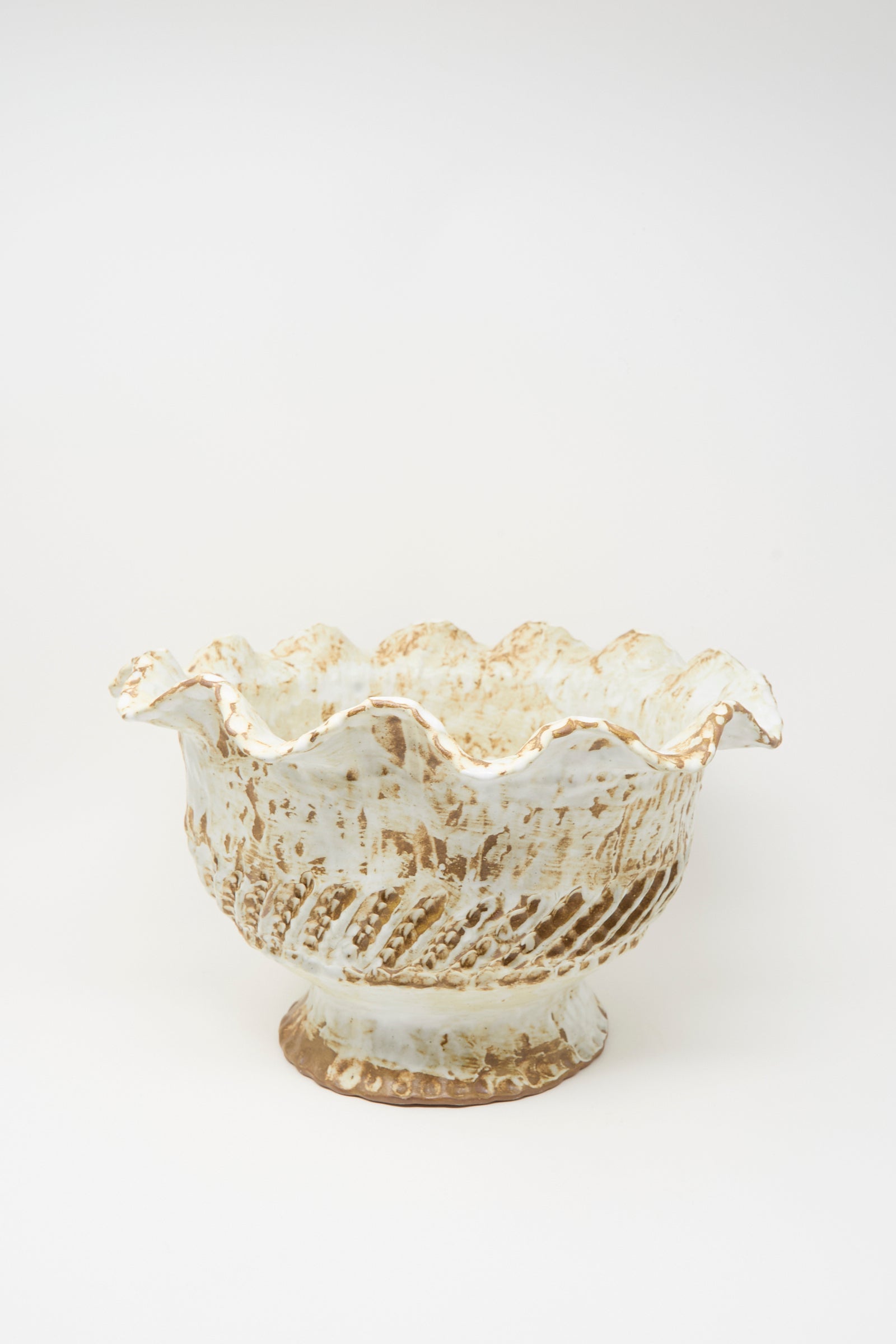 The Large Ridge Wave Bowl by Claire Resnick Ceramics is a hand-built ceramic piece featuring a scalloped rim, textured surface, and a blend of white and brown glaze. Made in the USA, it is photographed against a plain white background.