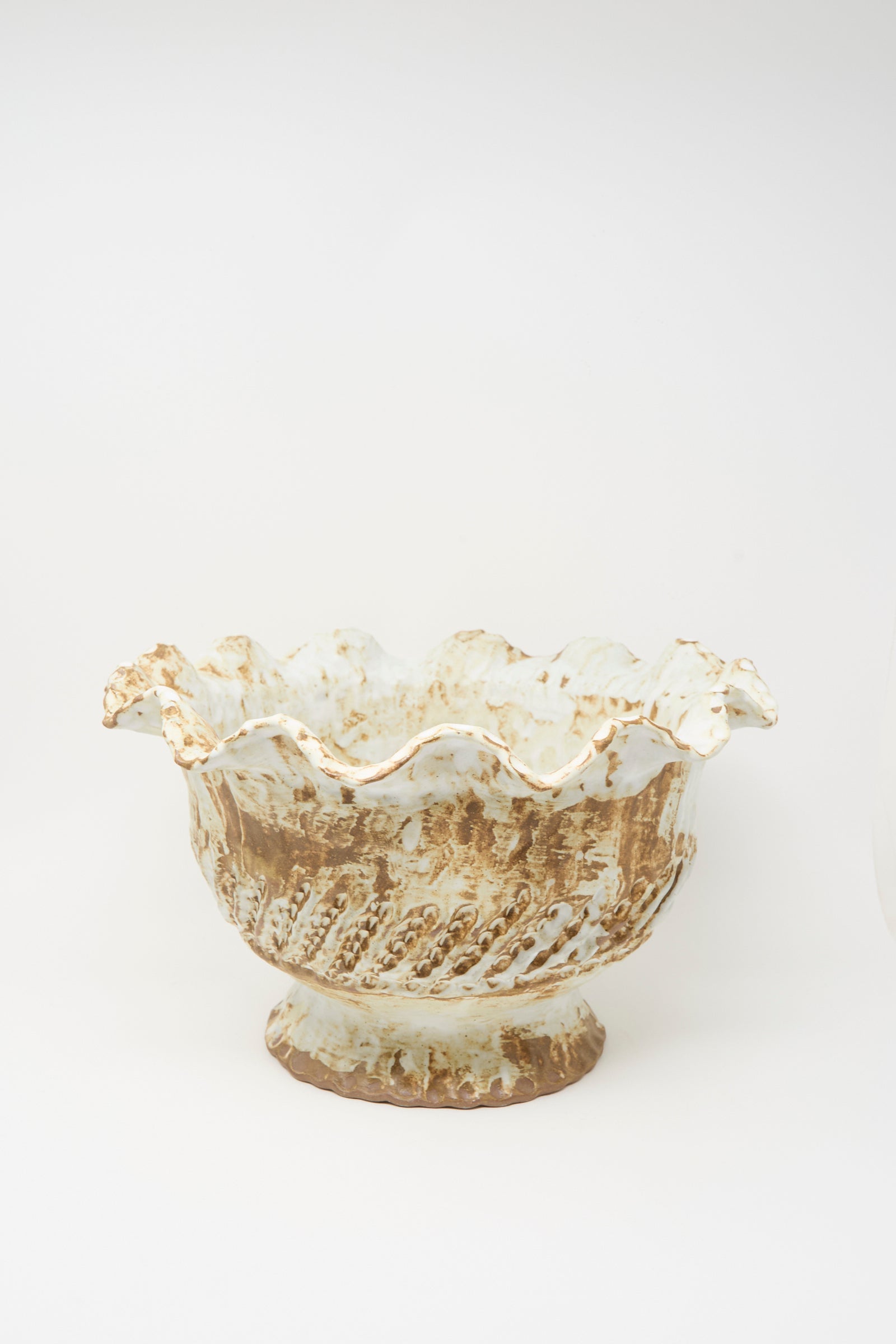 The Large Ridge Wave Bowl by Claire Resnick Ceramics is a hand-built ceramic piece featuring a fluted, ruffled edge and a textured, earthy brown and cream glaze. Made in the USA, it is shown against a plain white background.