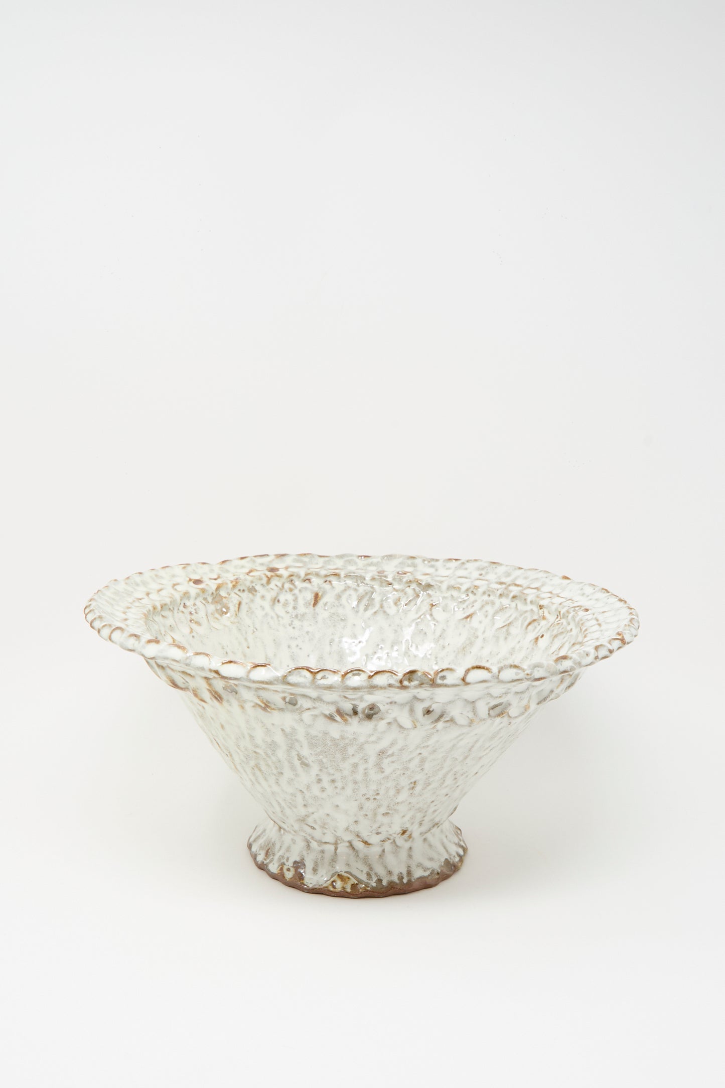 The Textured Bowl in White by Claire Resnick Ceramics features a wide, shallow shape with a slightly flared rim and a hand-applied, textured white glaze, presented against a plain white background.